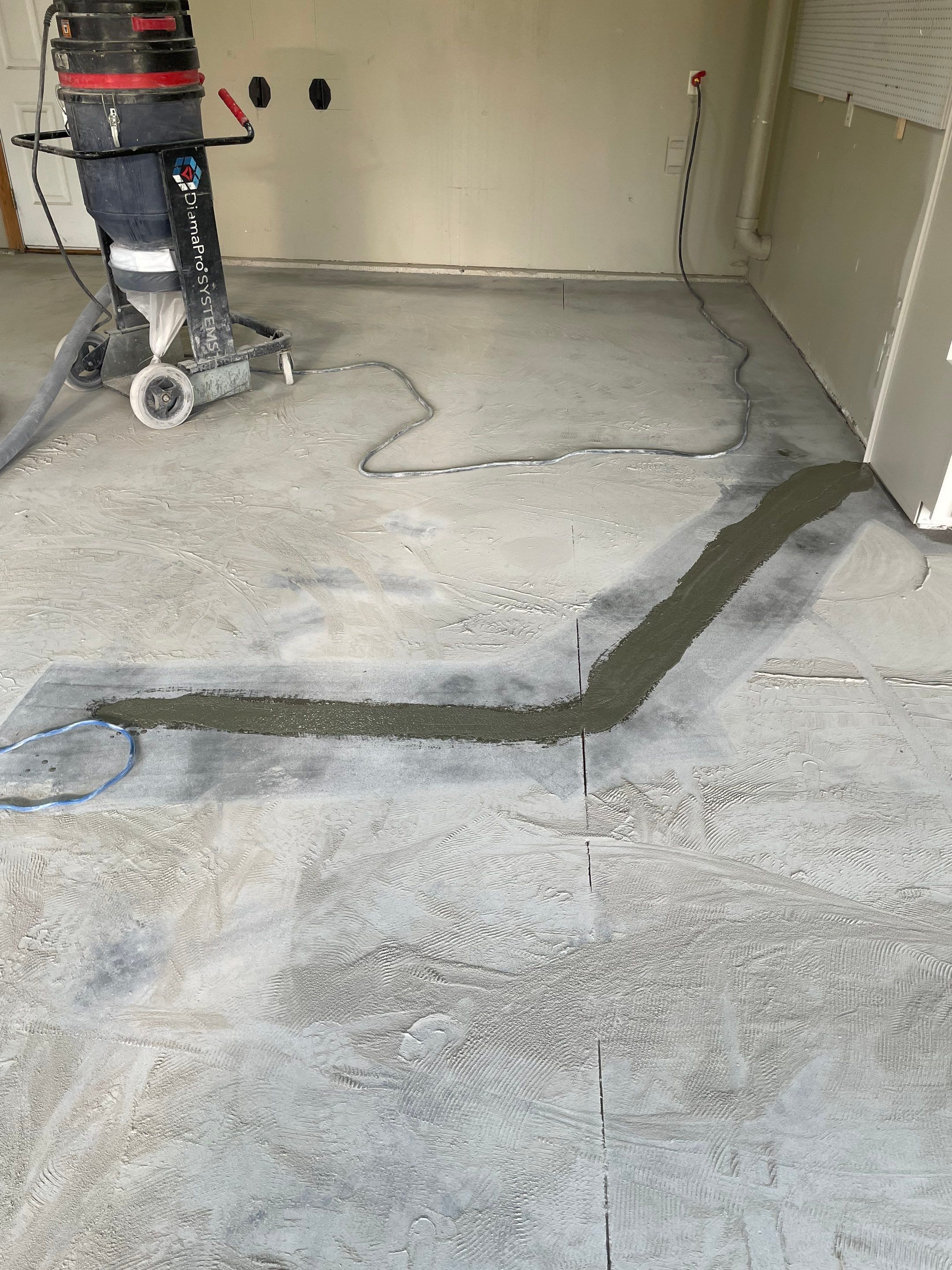 Cabin FEver Flake Garage Floor Coating Installation in Sioux Falls by Select Painting, Coatings & Garage Cabinets