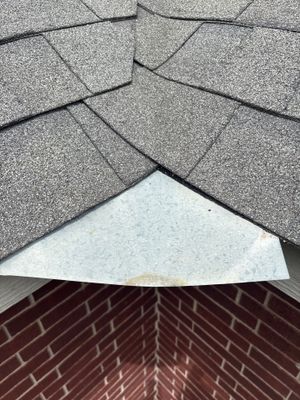 Close up of asphalt shingle valley with metal flashing