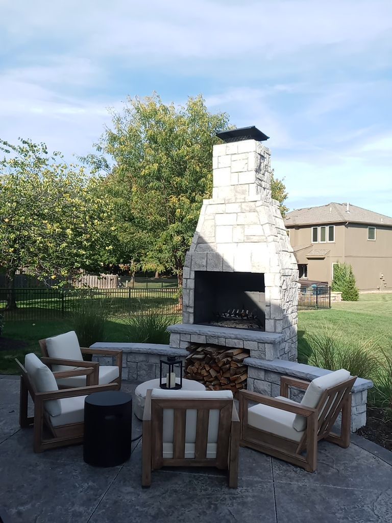 Back Yard Fireplace and Landscape by LAND ESCAPES LLC