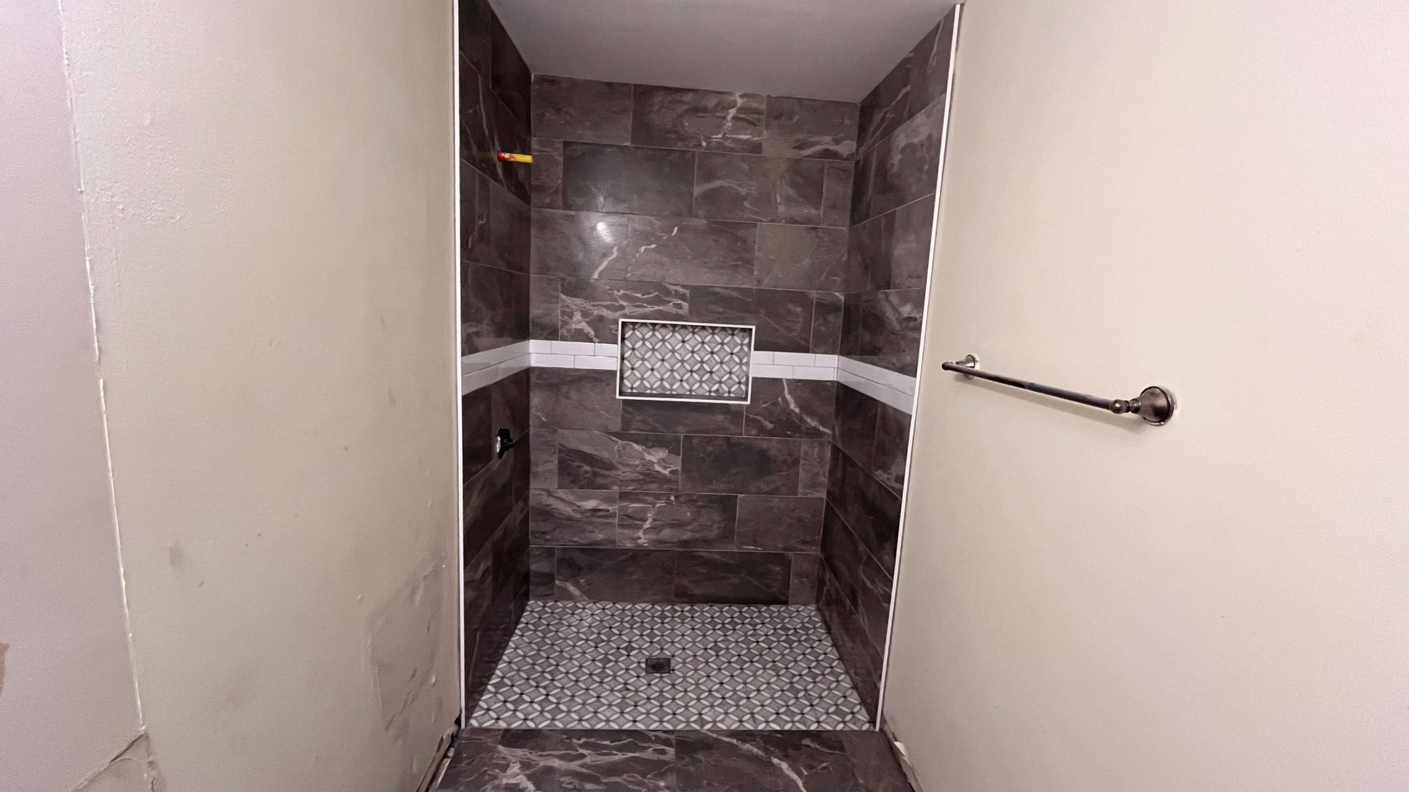 Tub to a curbless walk-in shower by Prudencio