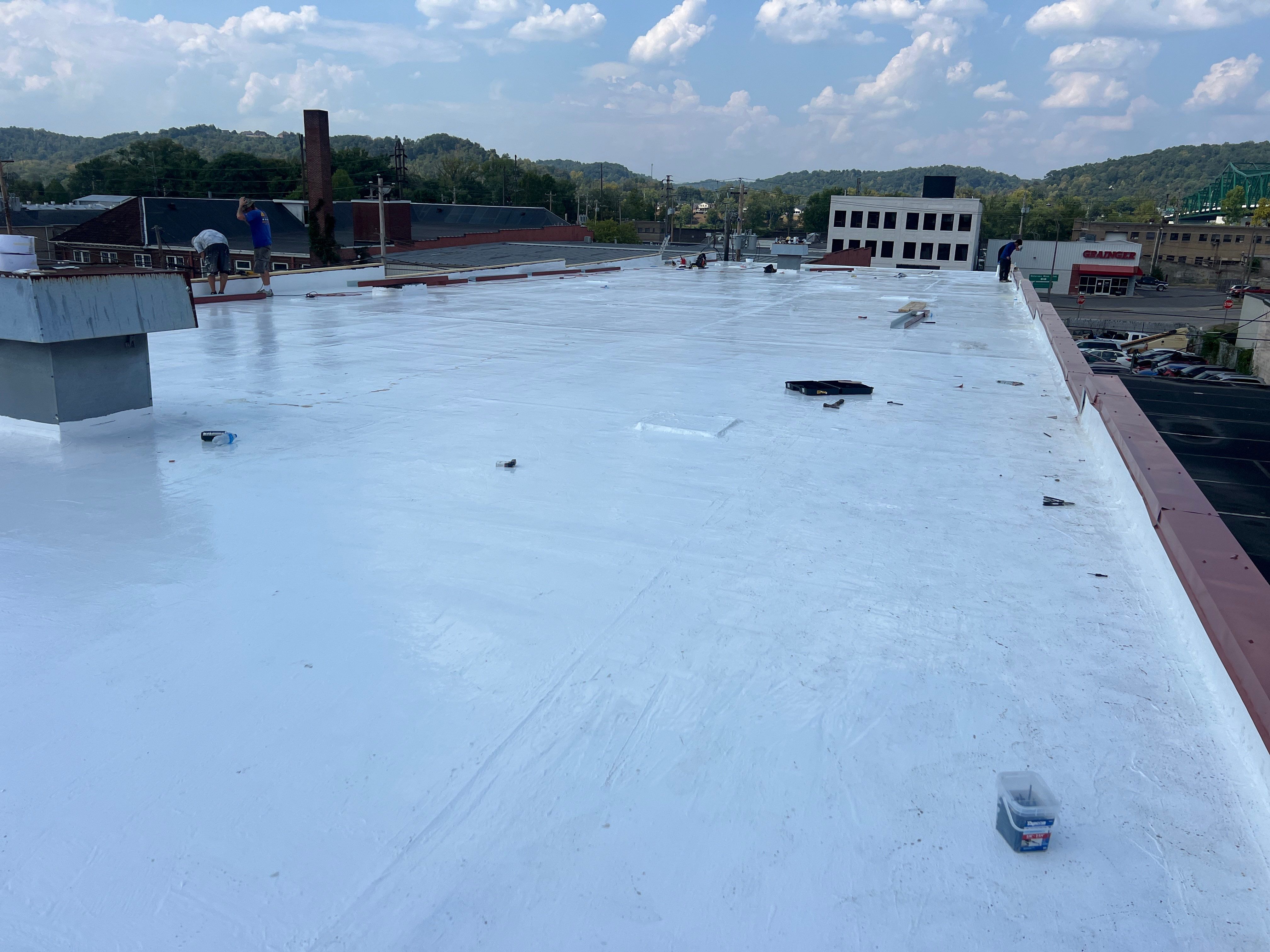 Commercial Roofing Installation using smartcoat Roof coating by Fahey Roofing + Contracting