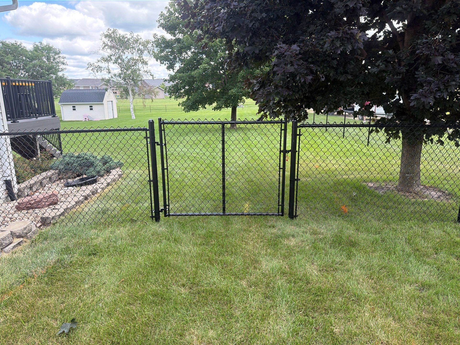 Black Vinyl-Coated Chain Link Fence Installation in Fairbank by Perfect Picket Fence and Stain