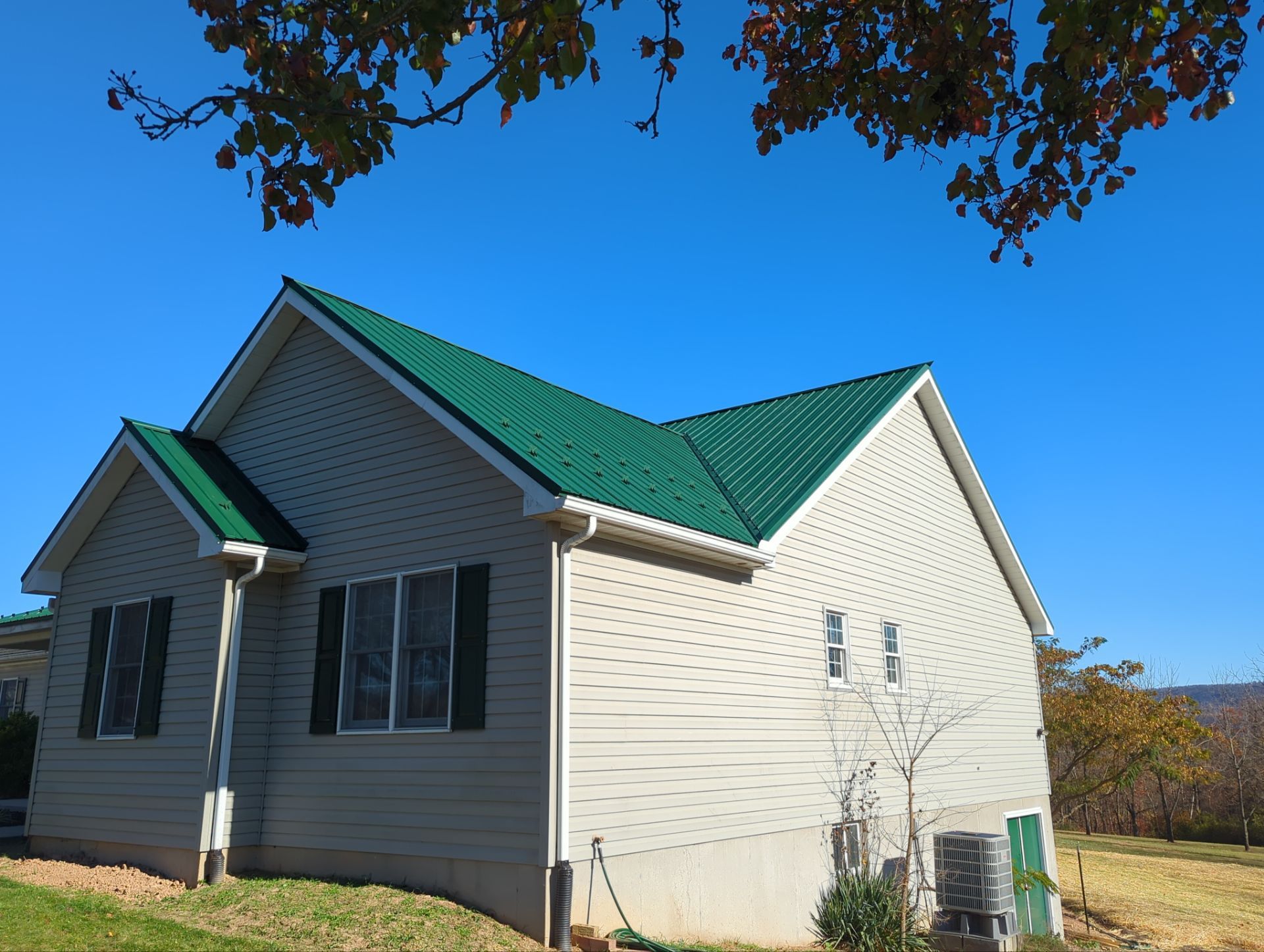 Green Metal Roof and Custom Covered Deck in Duncannon by Esh Builders