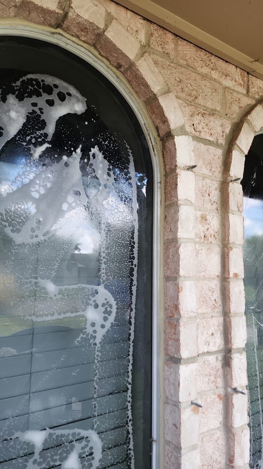 Colored Vinyl Windows to blend into brick by Bayfront Roofing and Construction