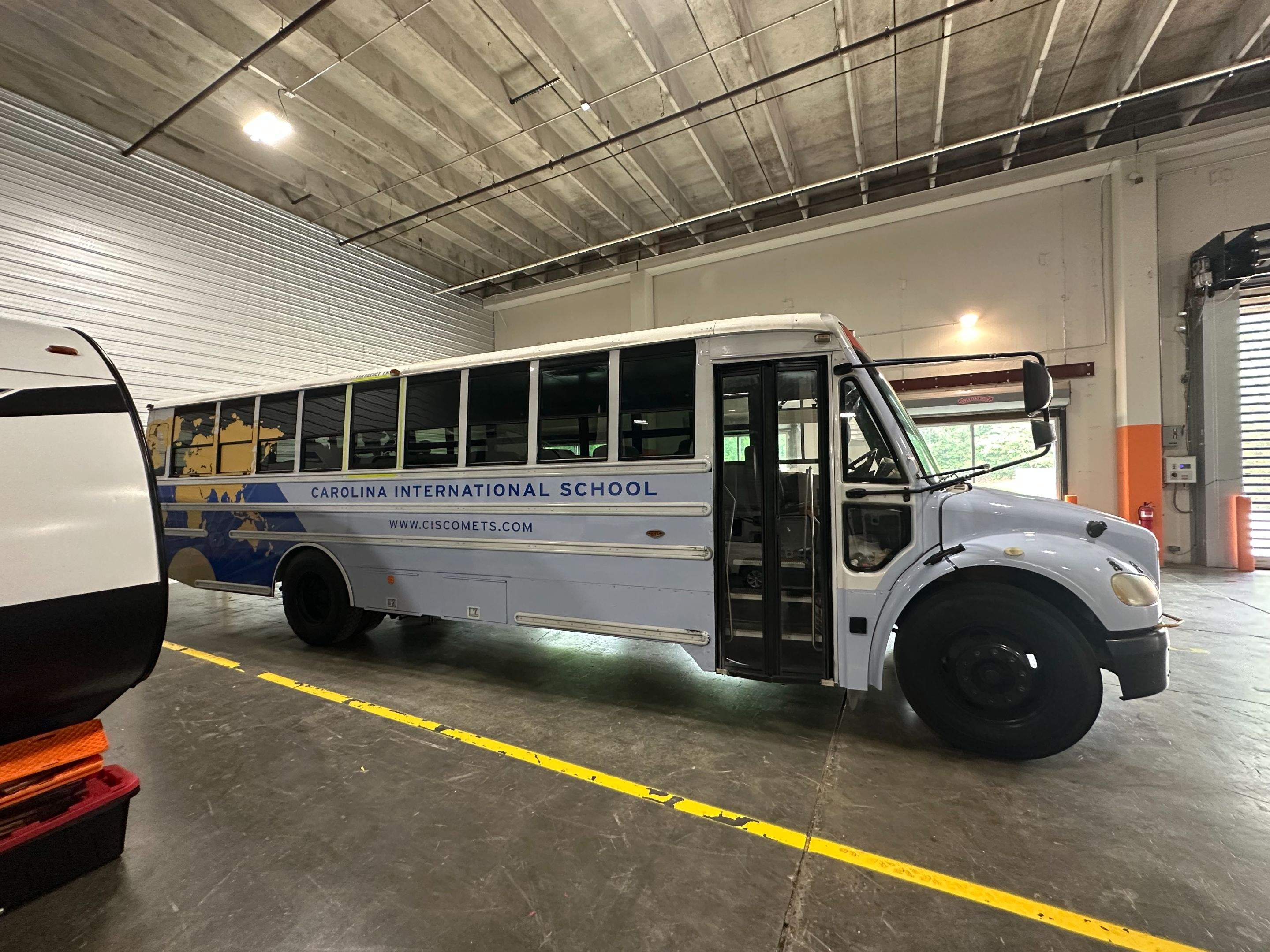 Carolina International School - Bus Vinyl Wrap by QC Signs and Graphics