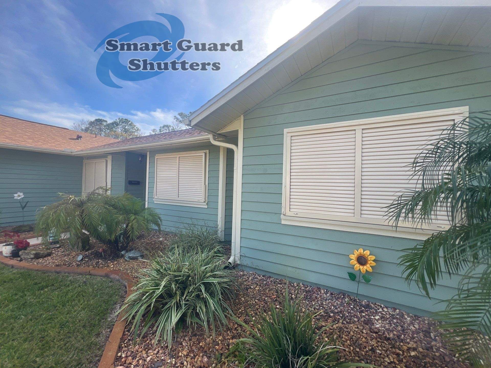 Impact Bahama Shutters in Light Ivory by Smart Guard Shutters