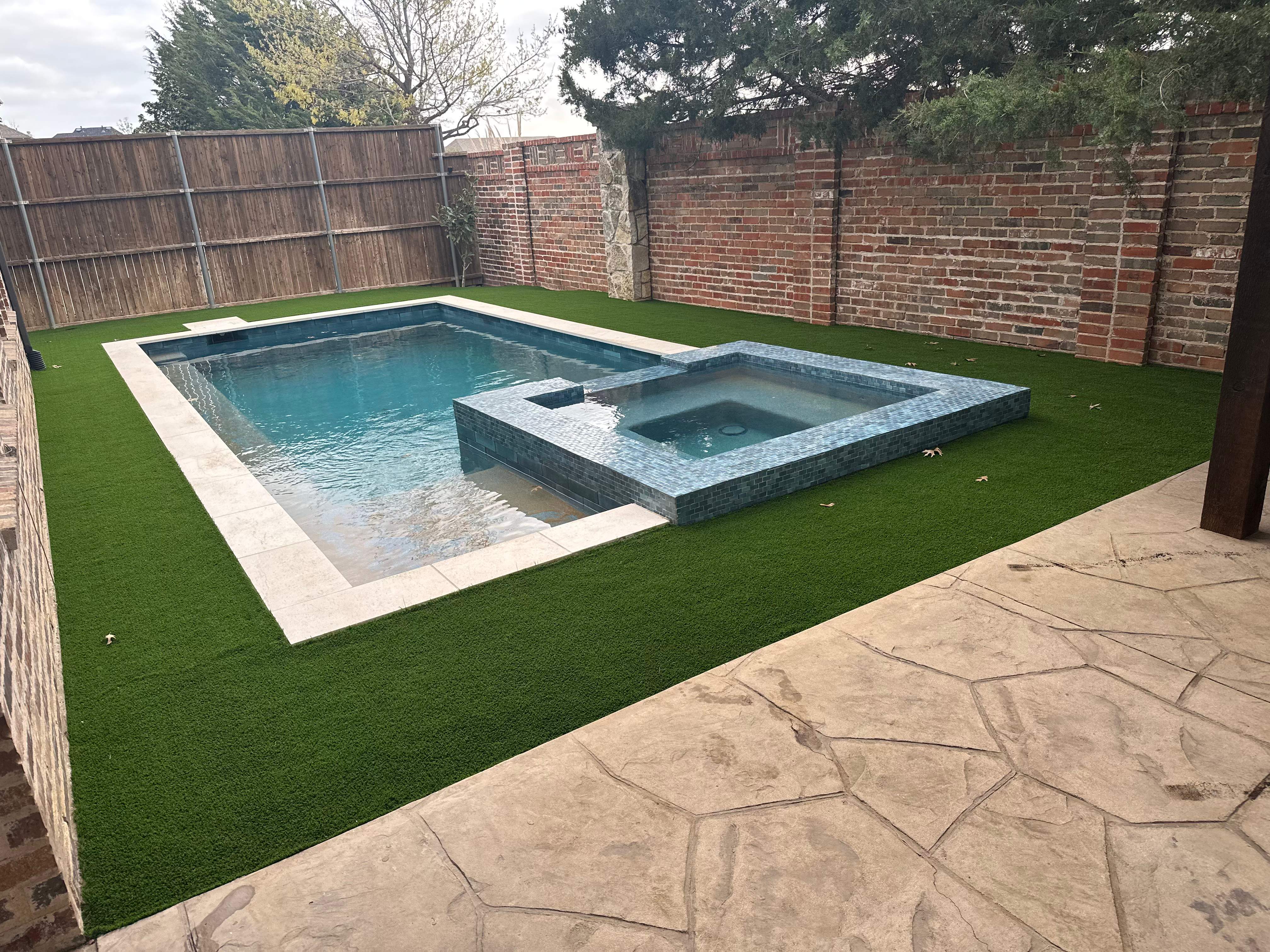Geometric Pool with Raised Stone Spa by Pinnacle Pools and Spas - DFW