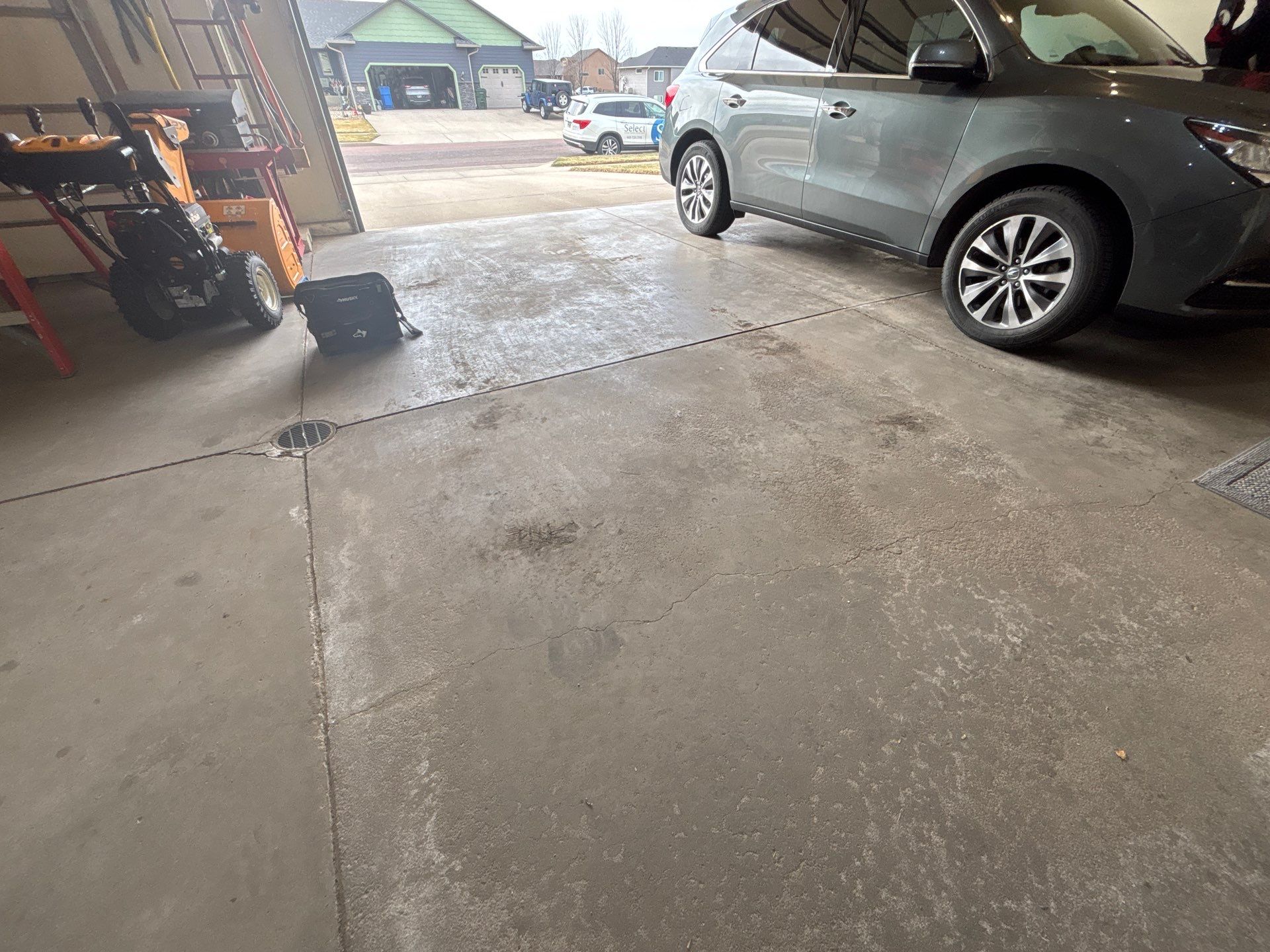 Sioux Falls Garage Floor Repair and Speckled Epoxy Coating Installation by Select Painting, Coatings & Garage Cabinets