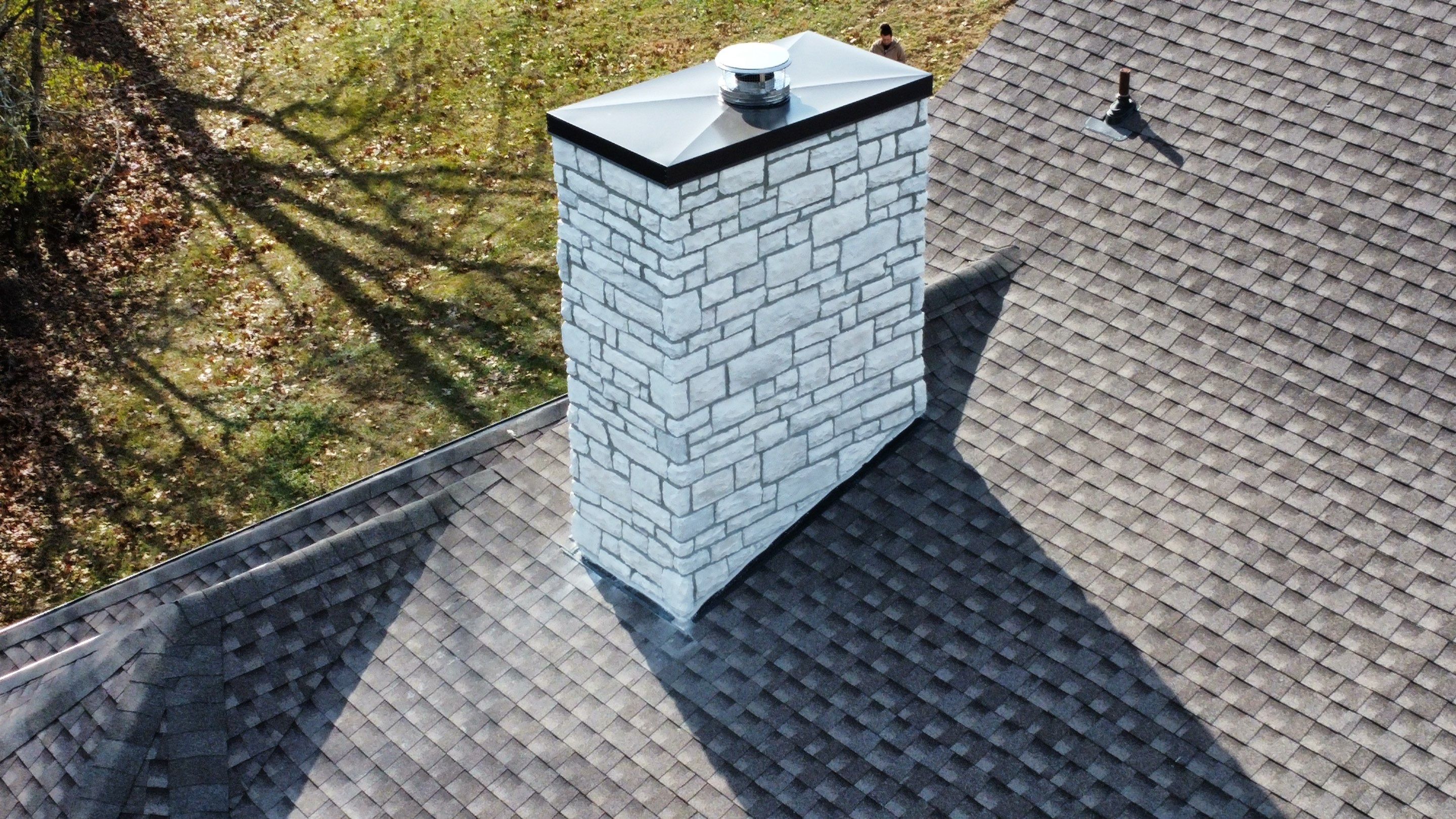 Roof and Gutter System Replacement with Stone Chimney Rebuild by Undersun Roofing 