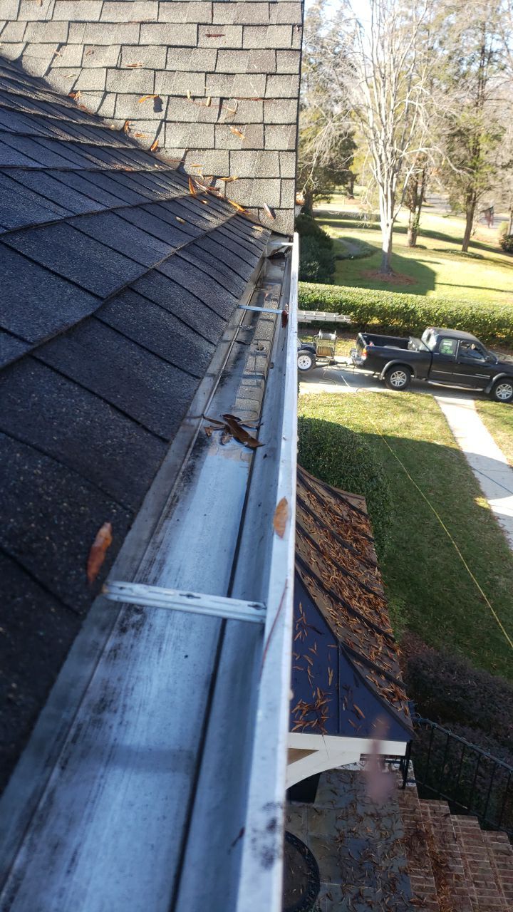 Sara Gutter cleanout using water by Power Wash Masters LLC
