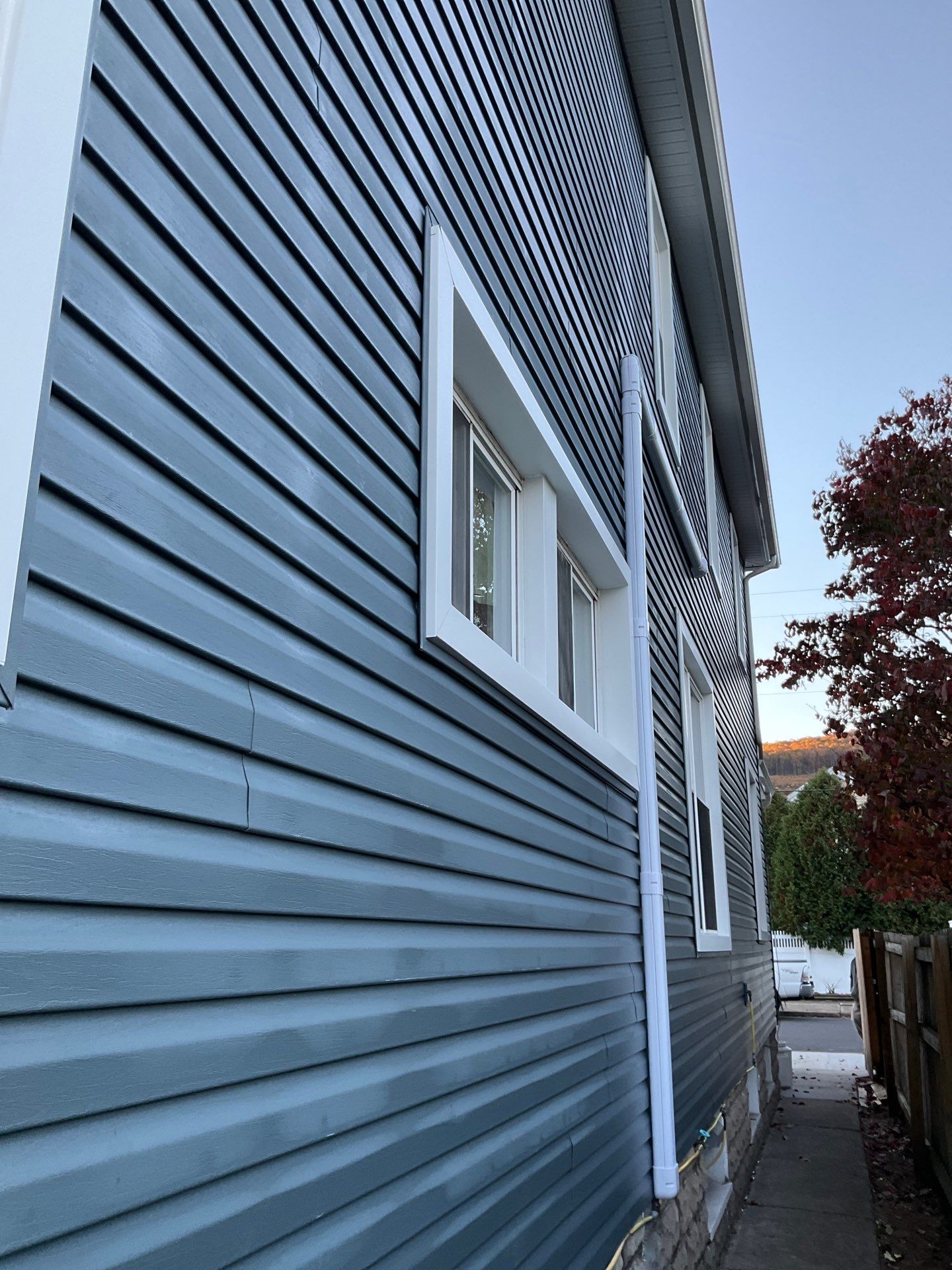 Charcoal Metal Roof & Blue Siding — A Refreshing New Look by Esh Builders
