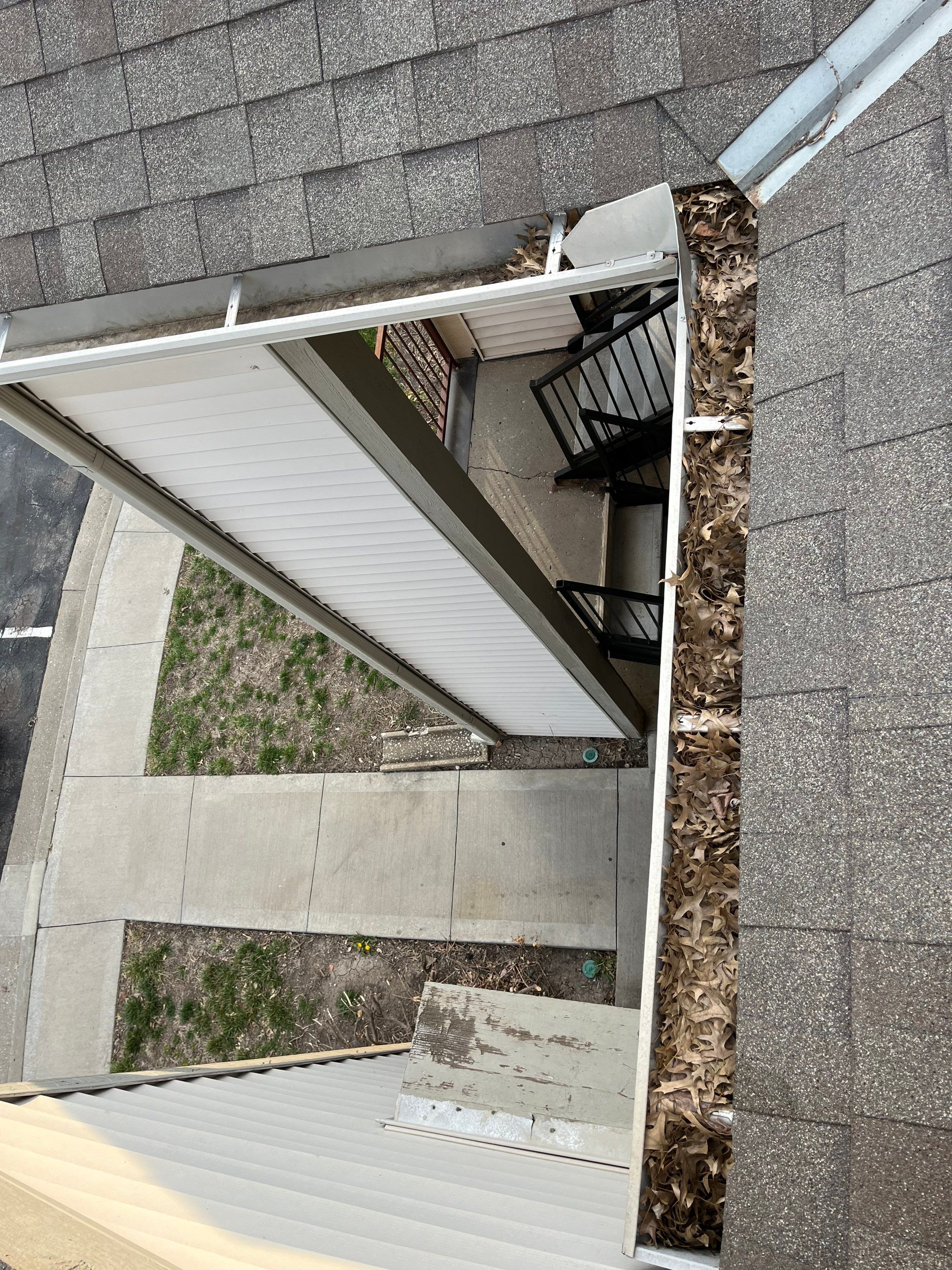 Commercial gutter cleaning Kansas City before photo with filled gutters