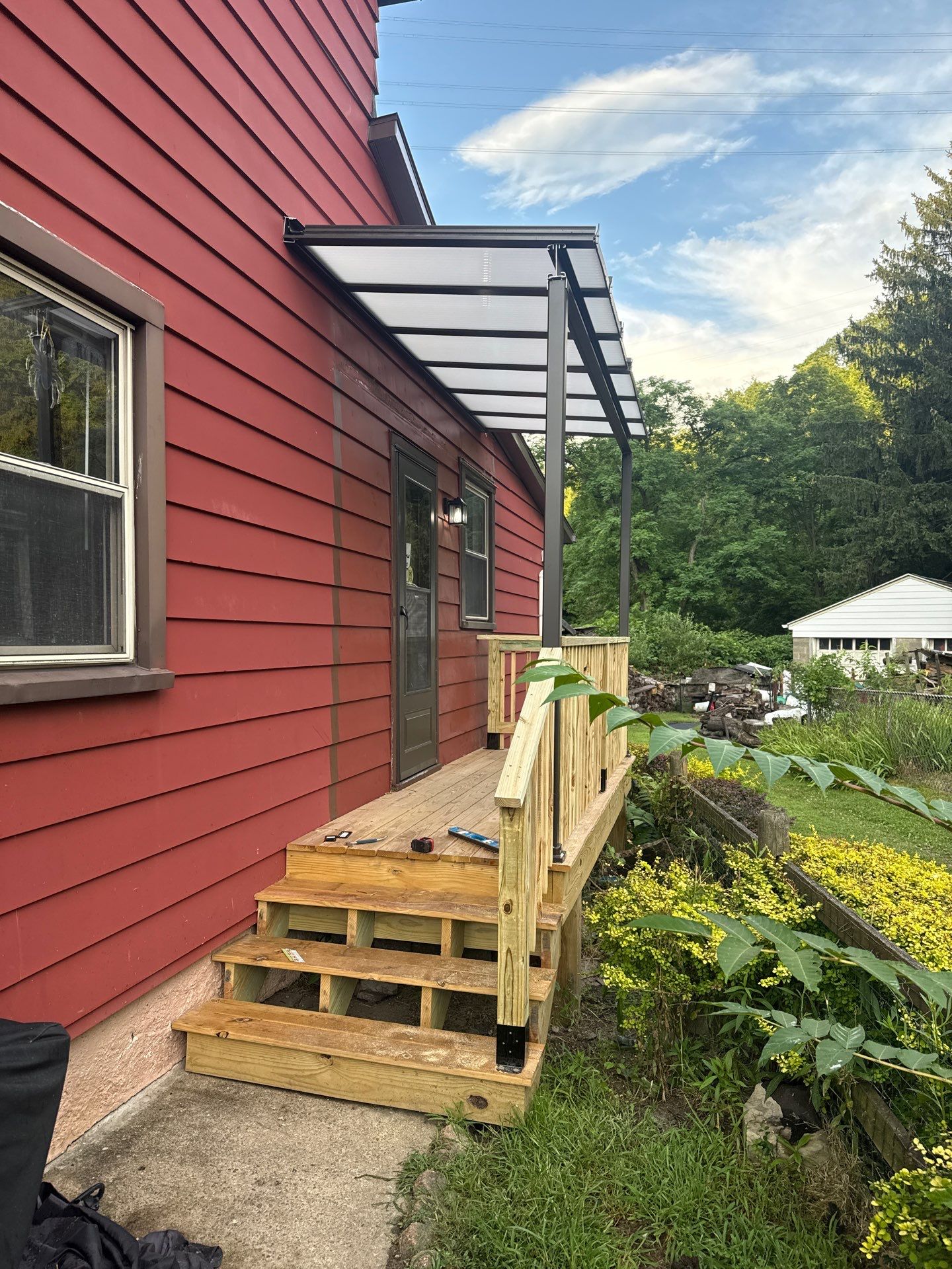 Roof sunspace deck  by Cousins Roofing Siding & Decks