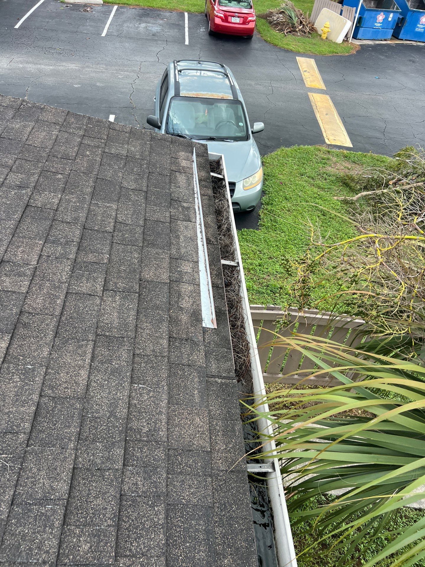 Commercial gutter cleaning Palm Bay & Melbourne before photo with filled gutters