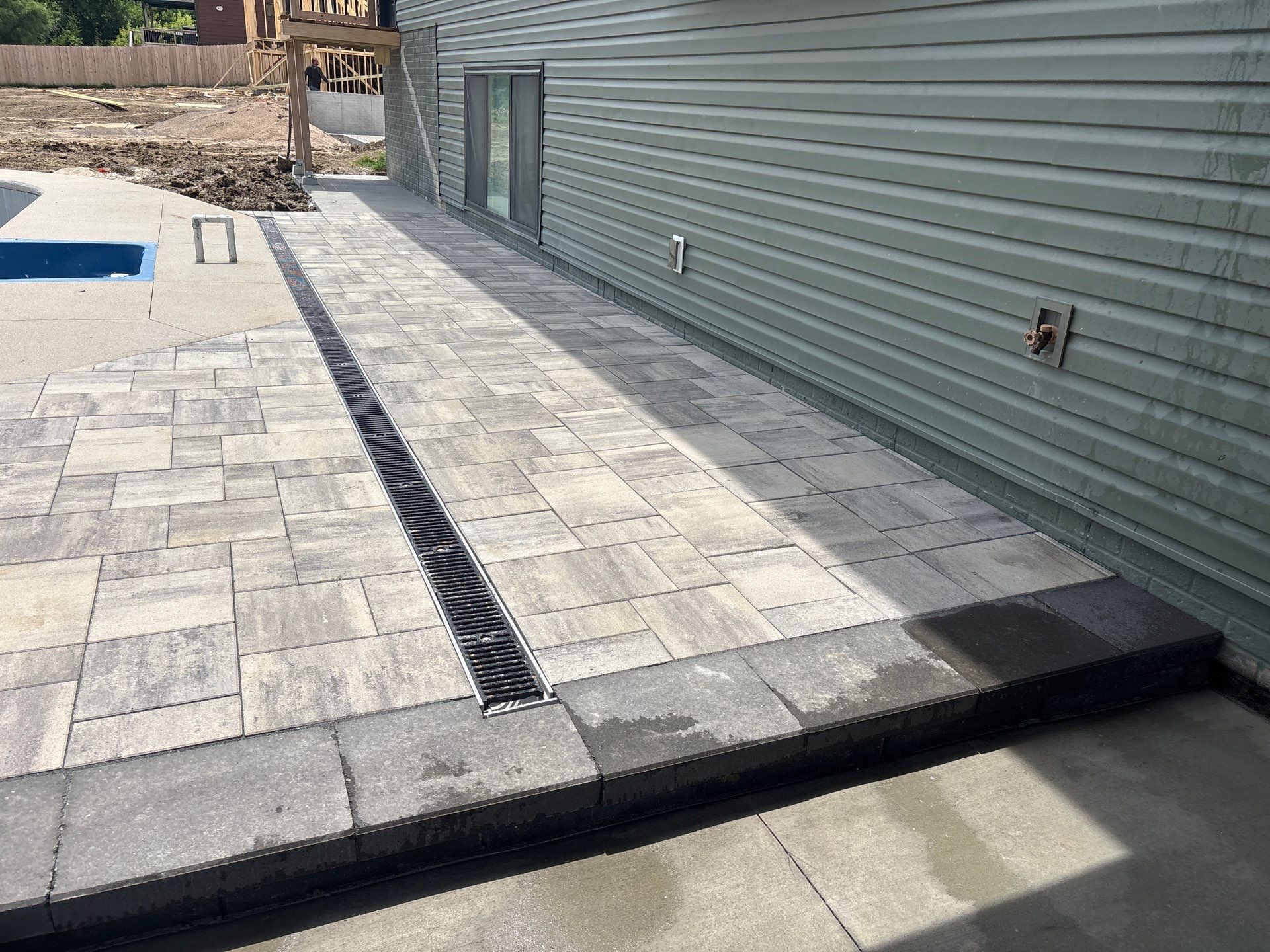 New Residential Construction - Paver, Putting Green, Pool by New Horizon Landscapes