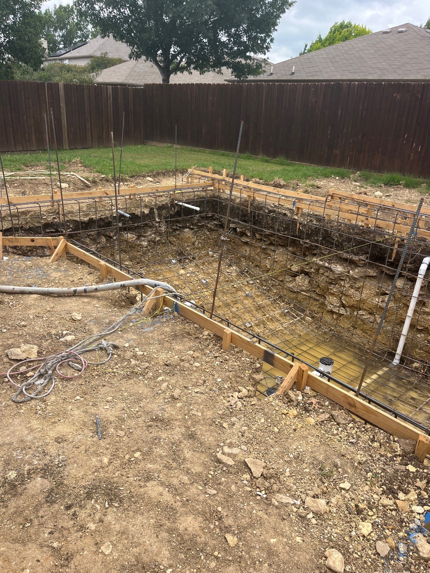 Modern Geometric Pool with Travertine Coping and Lush Landscaping by Pinnacle Pools and Spas - DFW