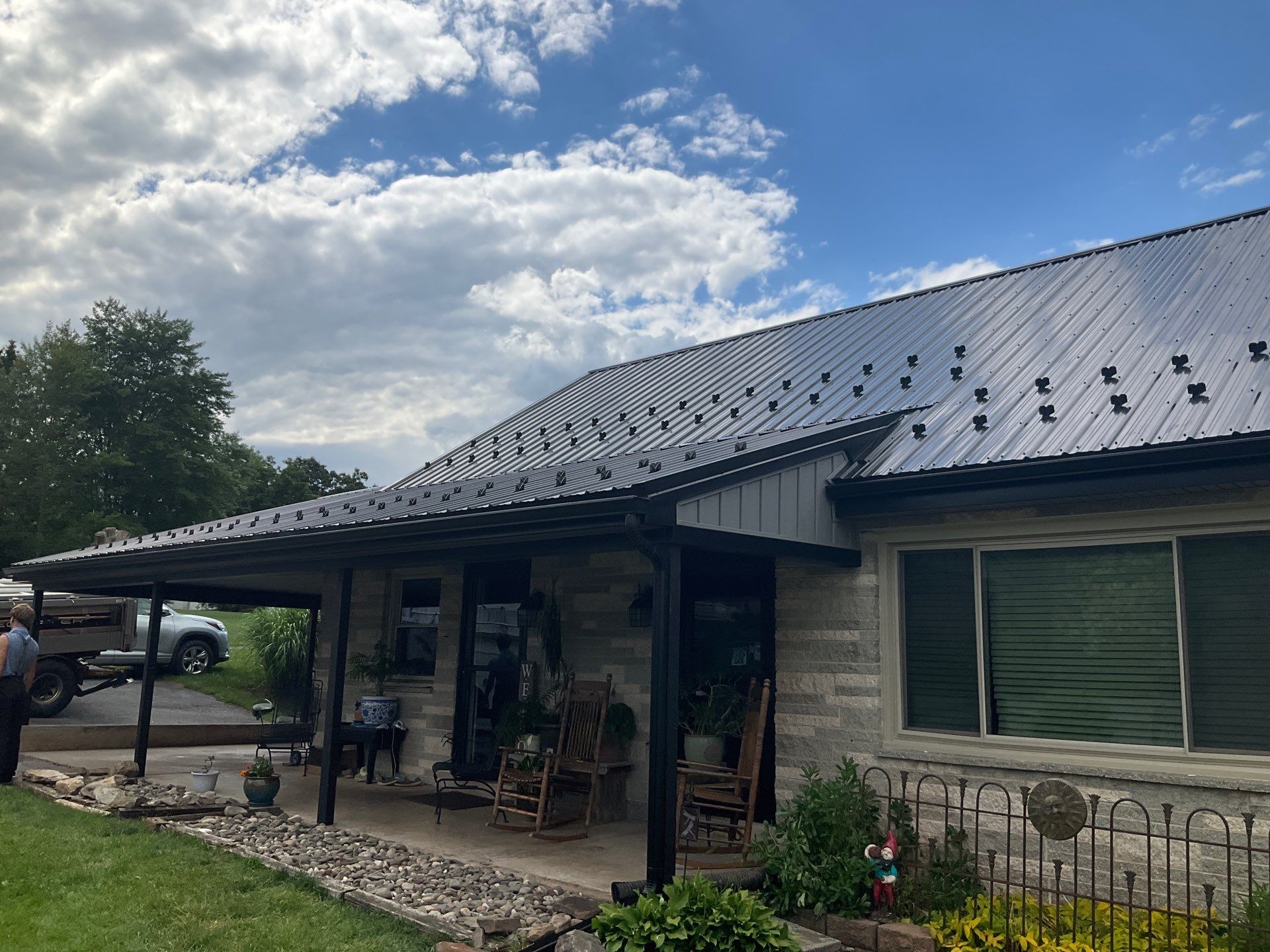 Metal Roofing, Board & Batten Siding, and Entry Door Transformation by Esh Builders