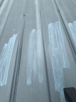 Close up of metal roof panel with chalk markings