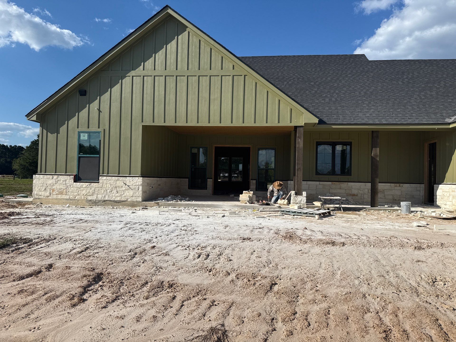 Cleveland Ranch Charm: Natural Stone Wainscot with Green Accent Siding. by Apex Conventional Stucco Llc