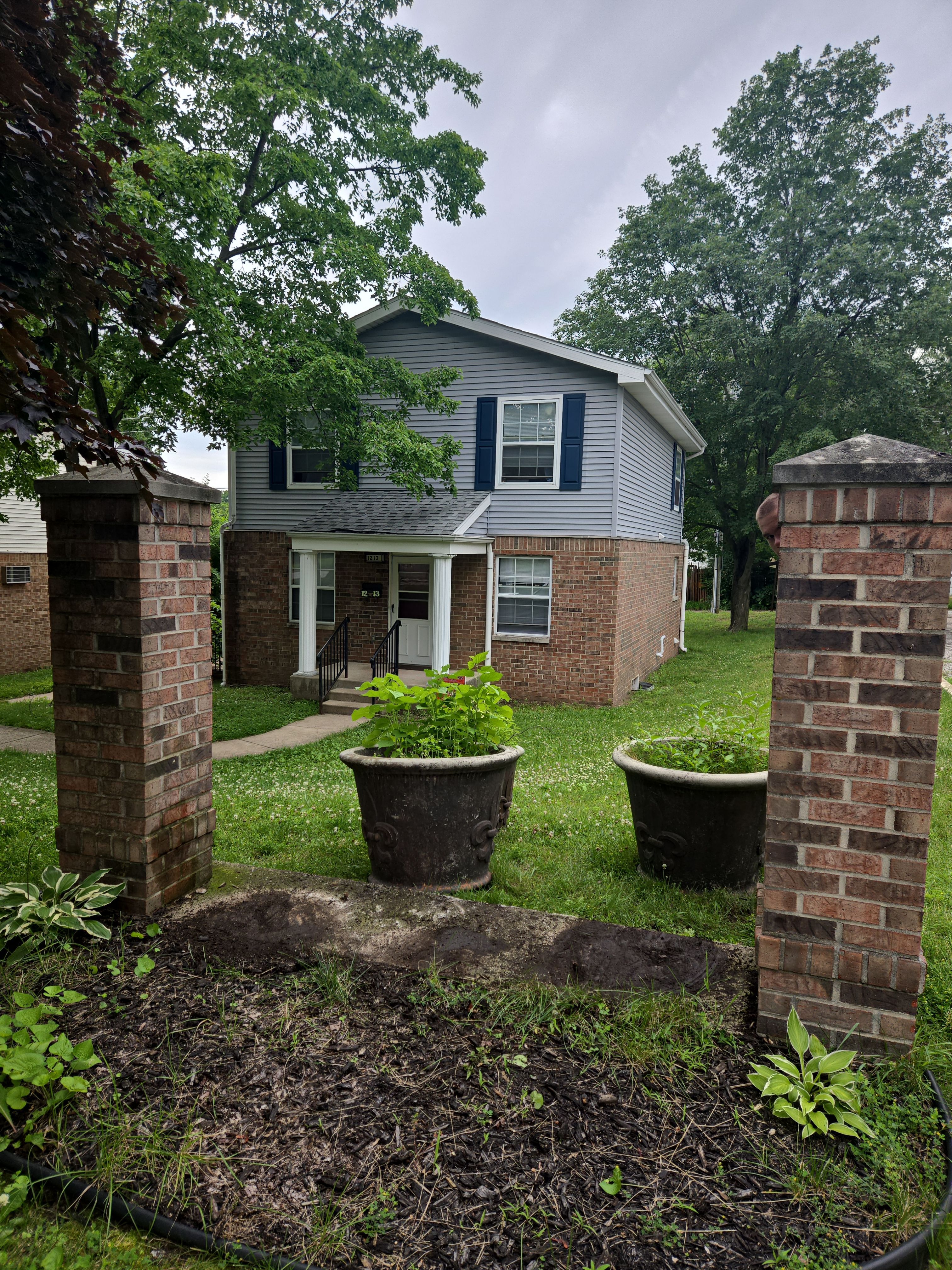 Monument Sign Installation Between Decorative Brick Pillars in South Bend by Hayes Design co