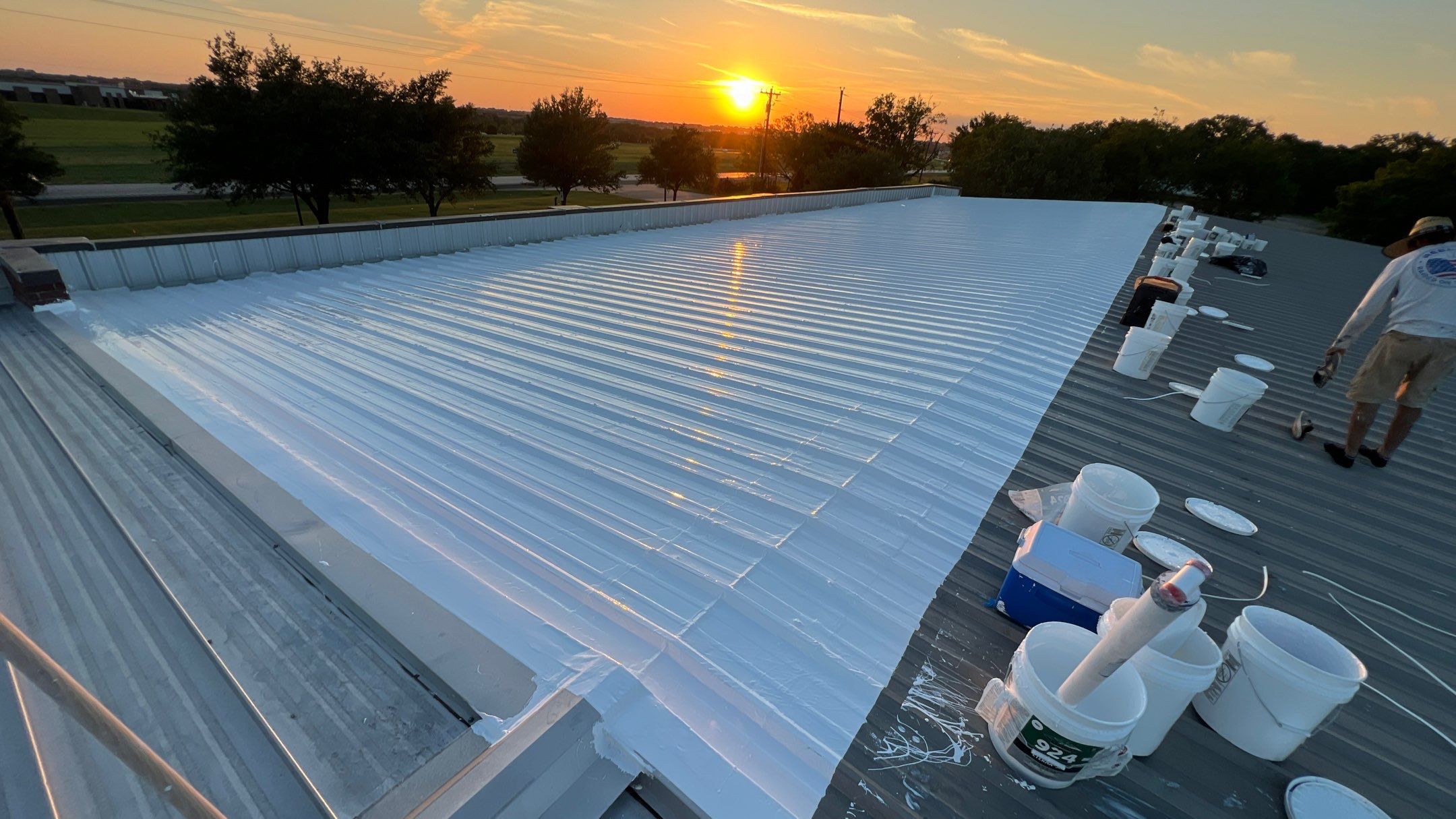 Commercial Roofing Installation using TRP #924 Eterna-Sil Premium Silicone Roof Coating by Harvey Roofing & Construction