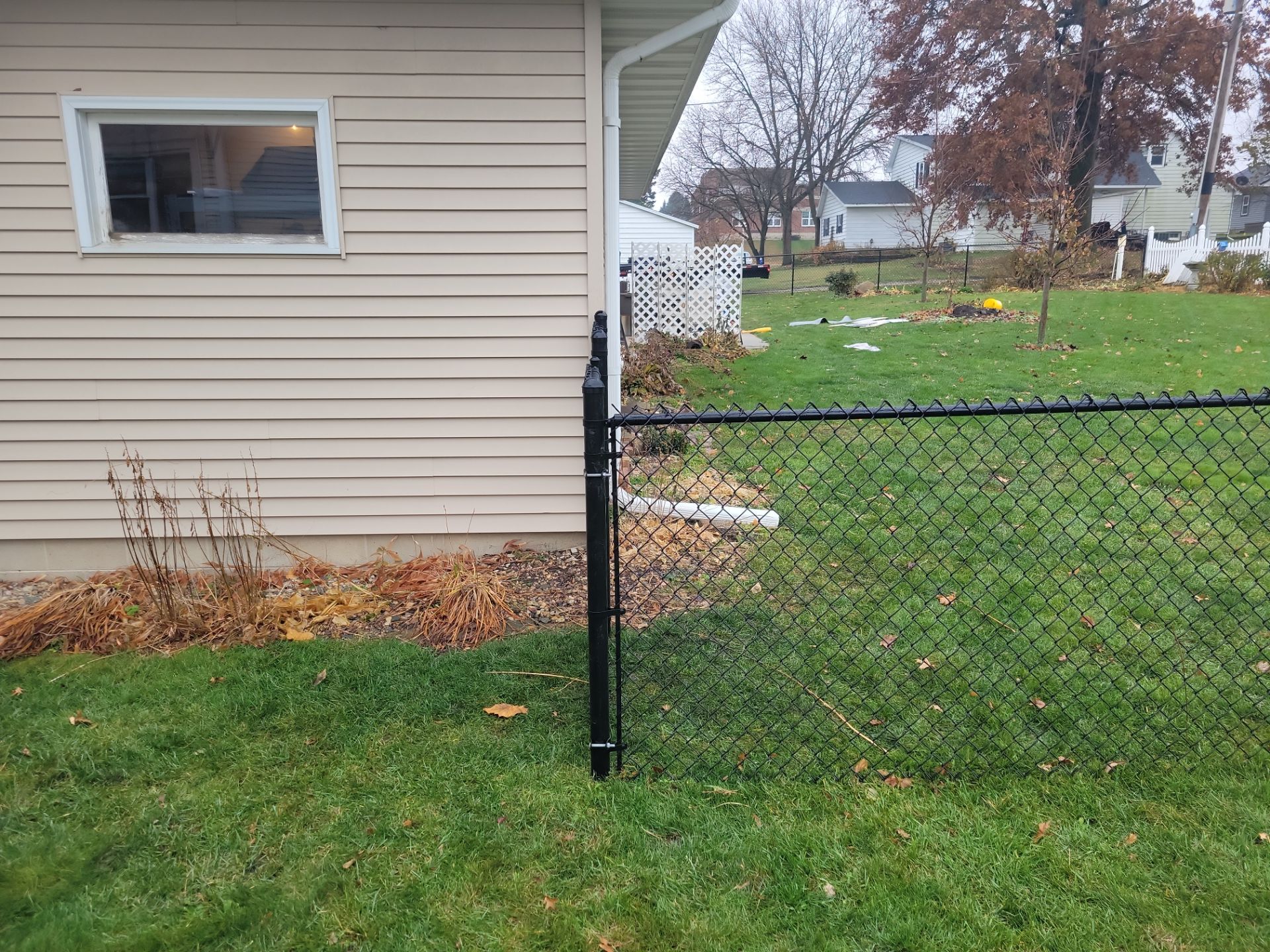 Black Vinyl-Coated Chain Link Fence Installation in Aplington by Perfect Picket Fence and Stain