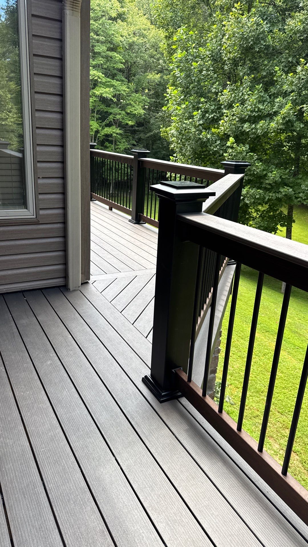 Custom Composite Deck Construction with Stone Pillars in Fayetteville by Walnut Hollow Decks & Outdoor Living