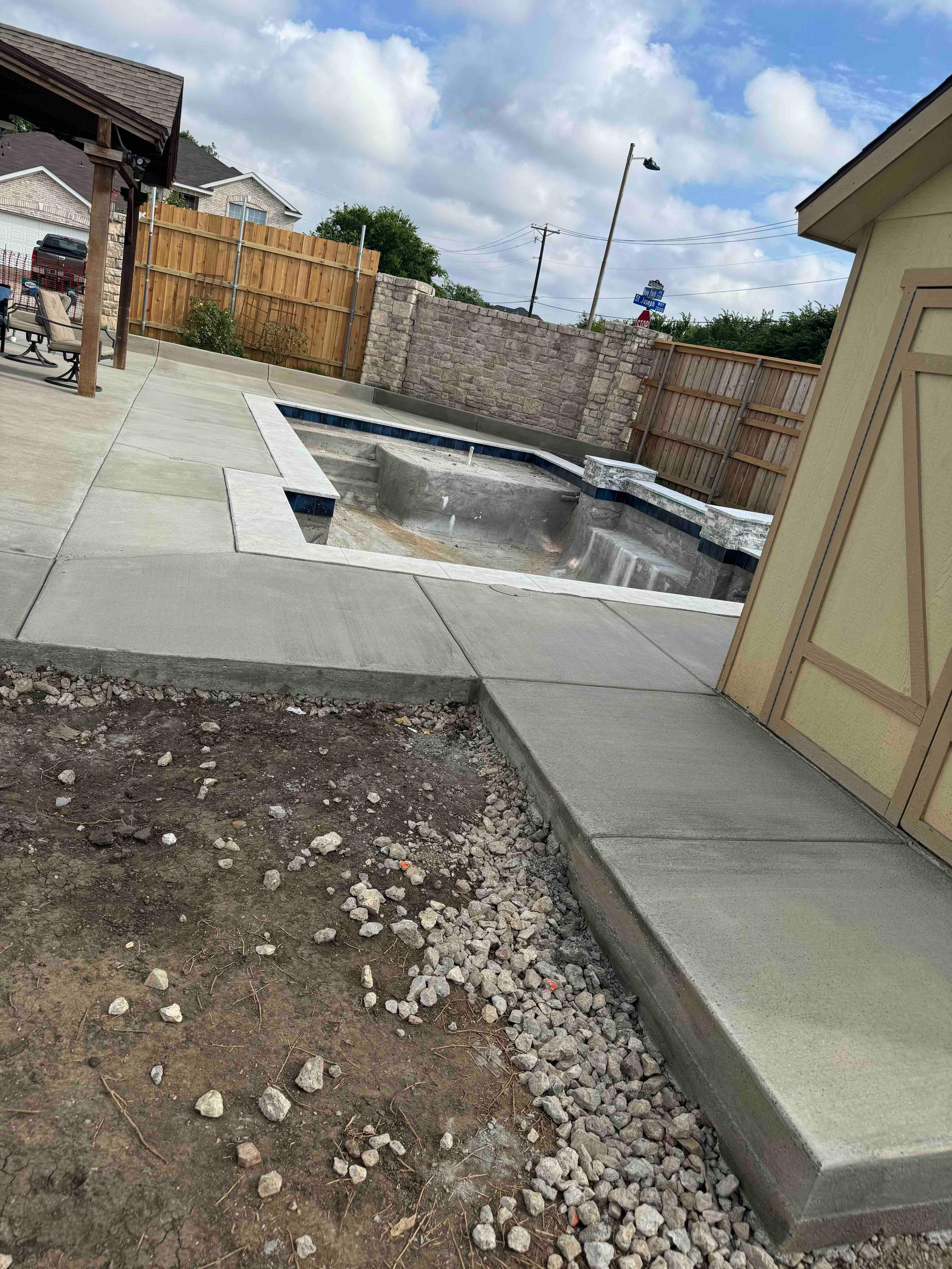 Geometric Pool with Raised Stone Accent Wall by Pinnacle Pools and Spas - DFW
