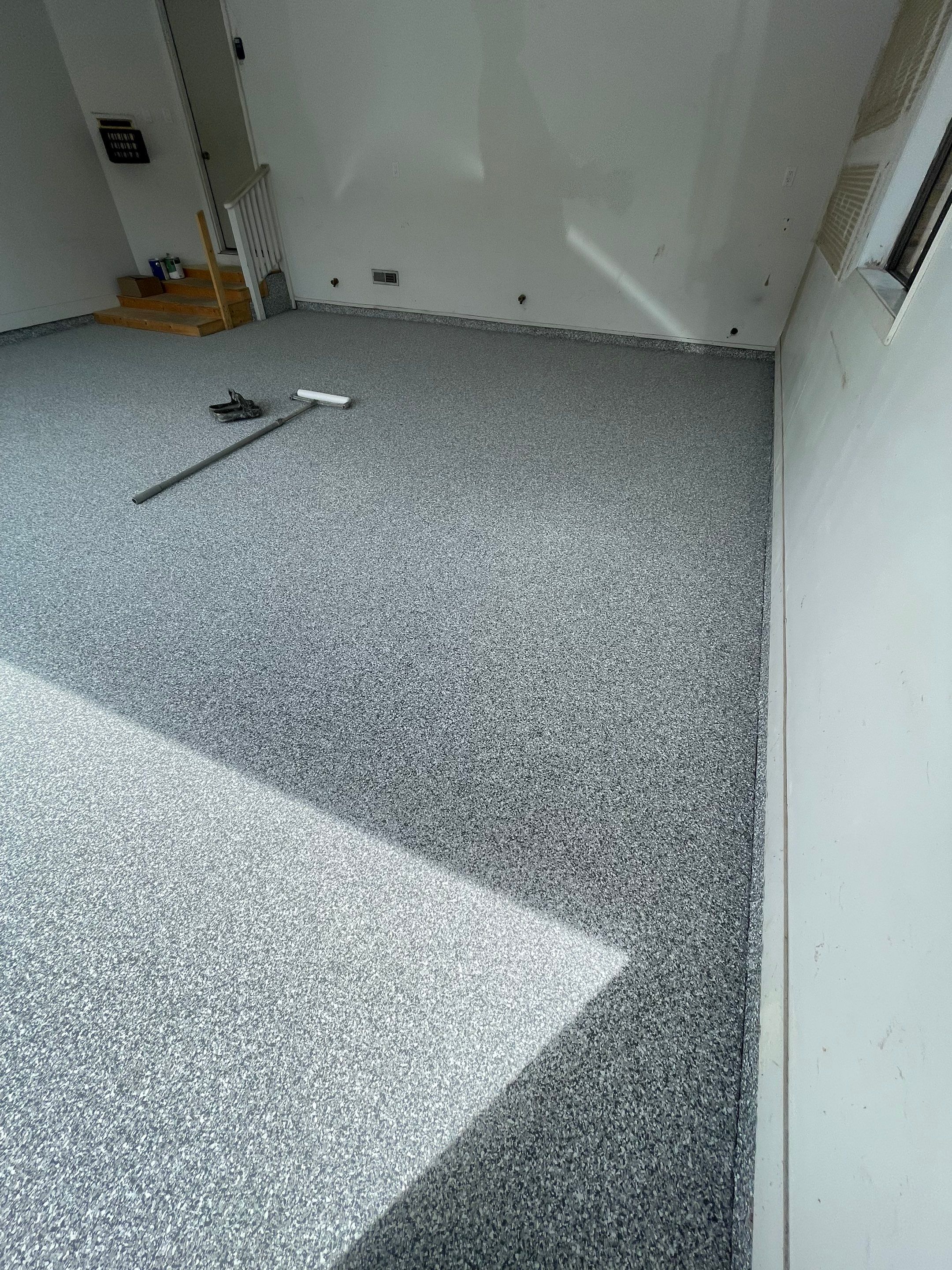 Grey Speckled Concrete Coating for Residential Garage in Yankton by Select Painting, Coatings & Garage Cabinets