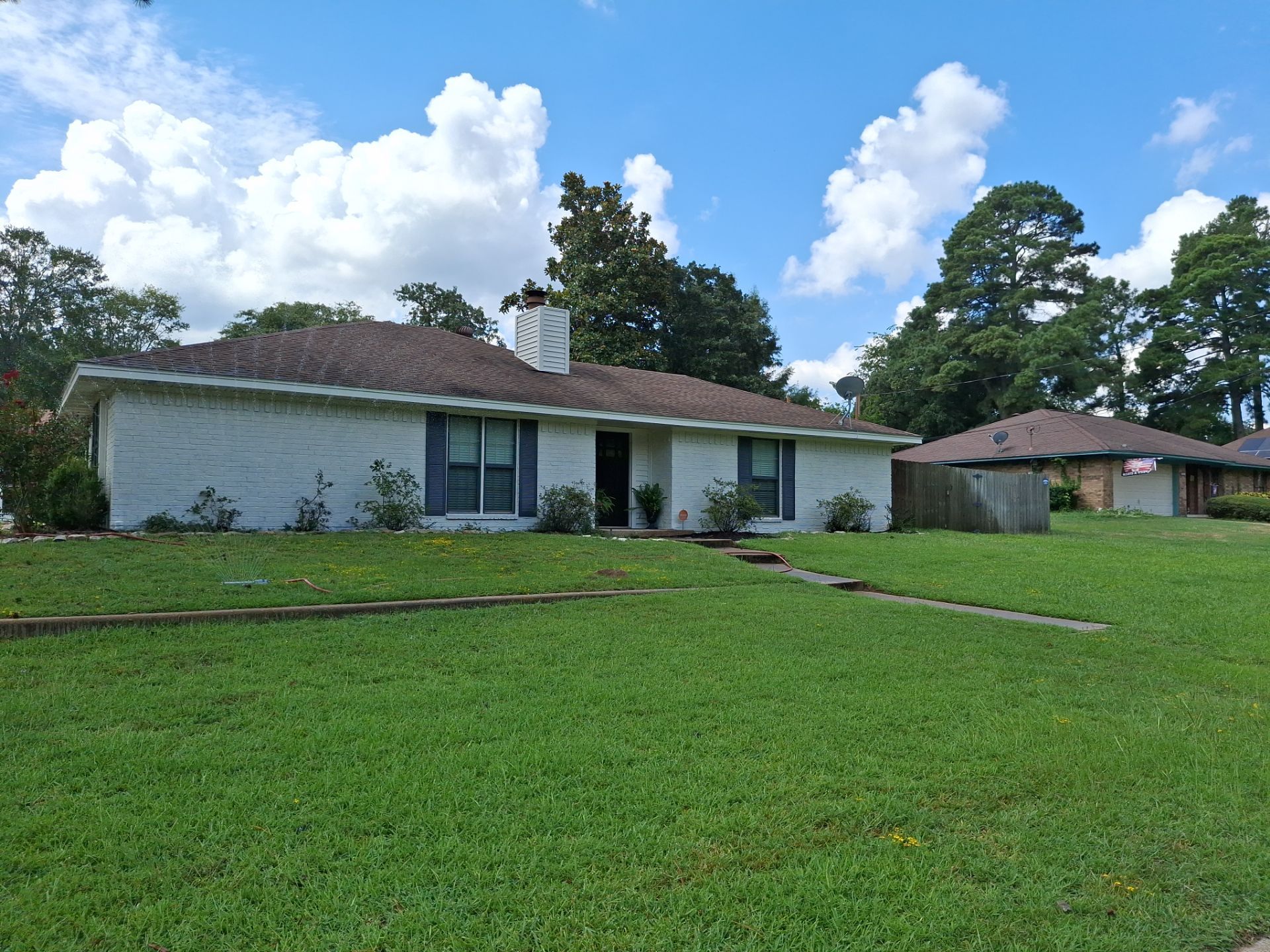 Exterior Painting in Flint, TX | White Brick Home & Metal Building with Sherwin-Williams Duration by Quality Coats Painting