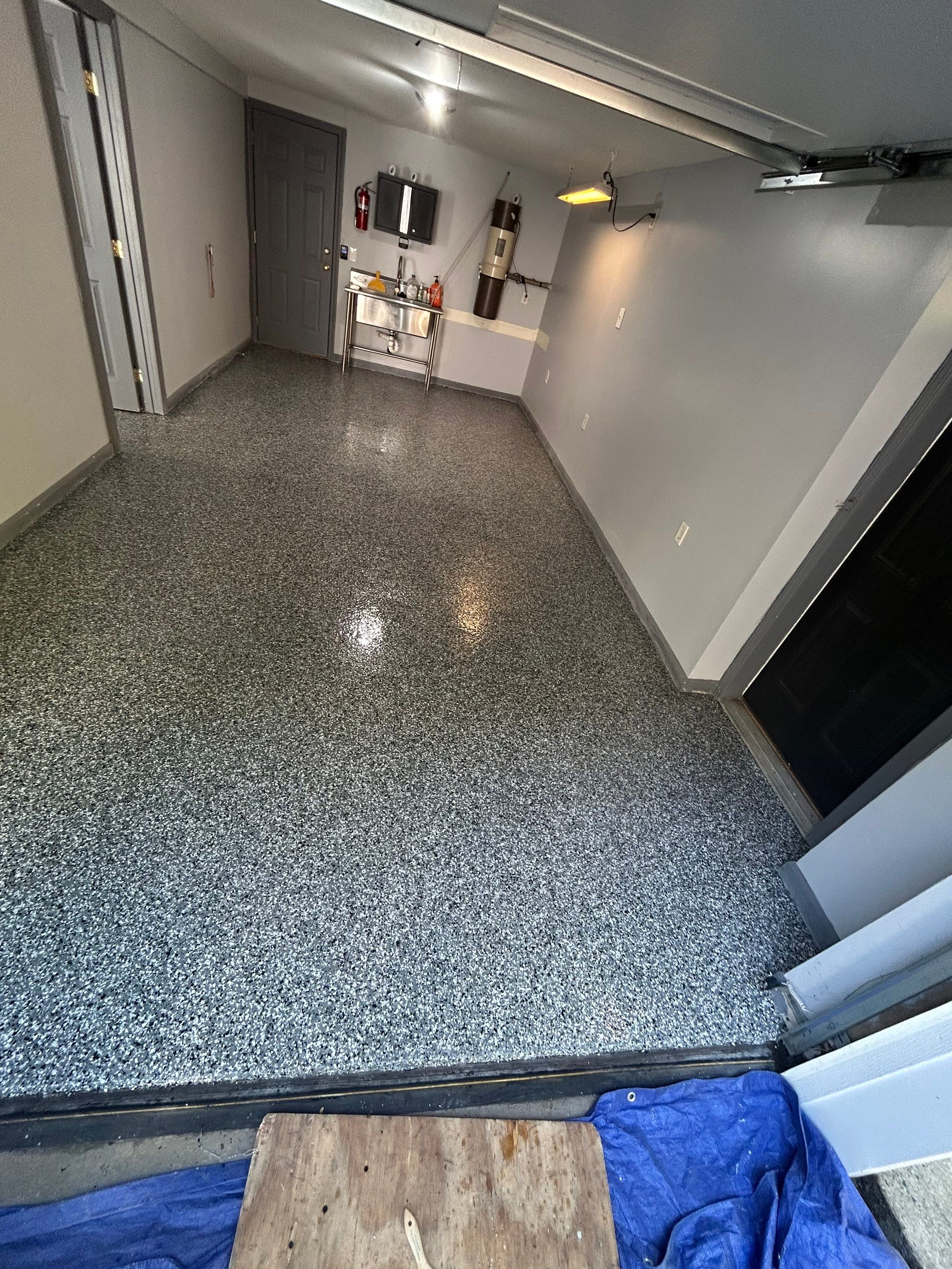 Concrete Floor Coating Transformation by DiGiorgi Roofing and Siding Inc