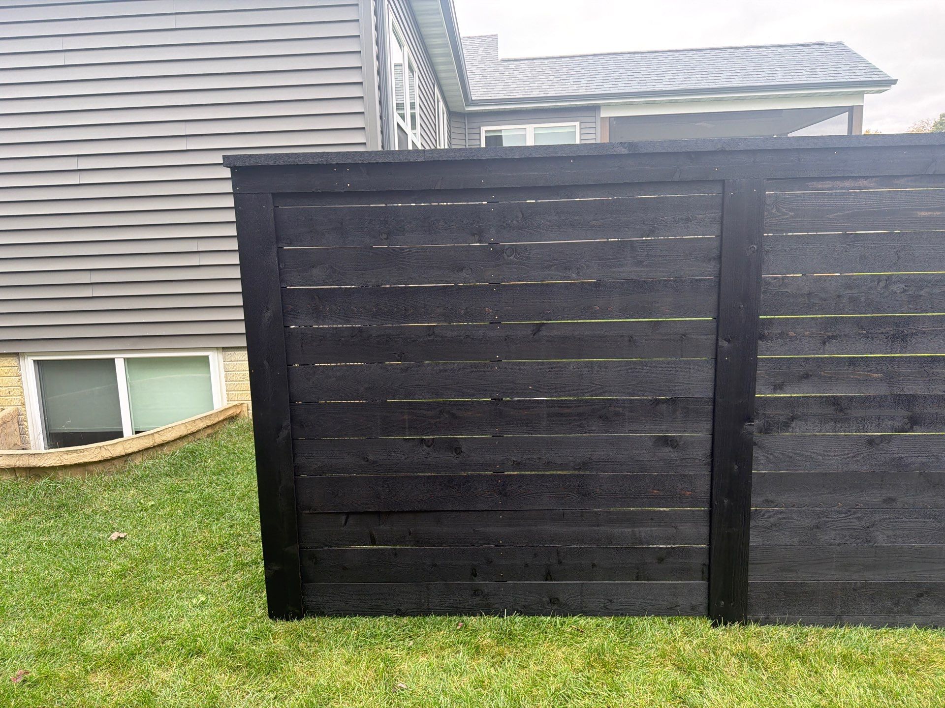 Modern Horizontal Wood Privacy Fence Installation in Cedar Falls by Perfect Picket Fence and Stain
