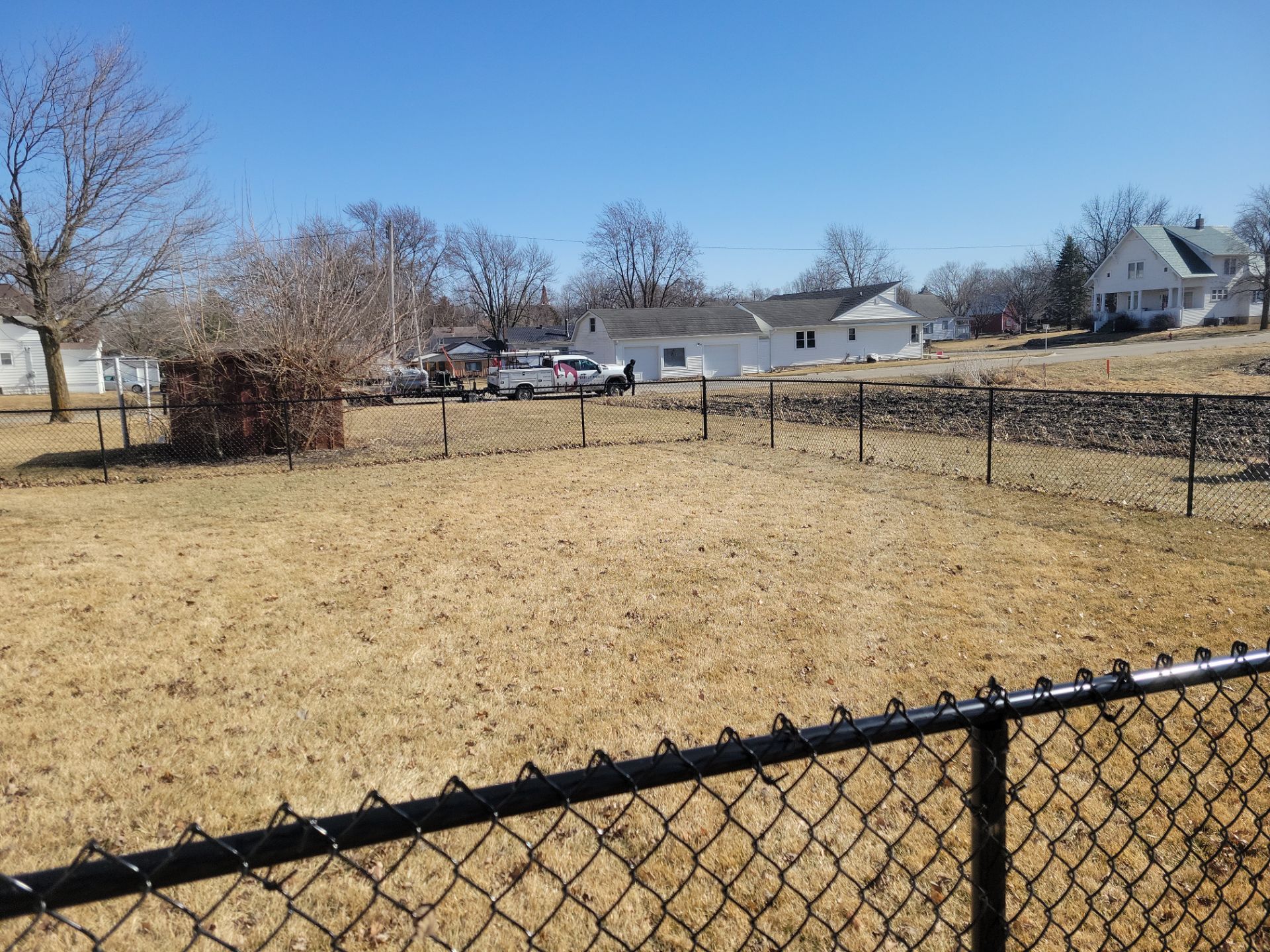 Residential Black Chain Link Fence and Gate Installation in Tripoli by Perfect Picket Fence and Stain