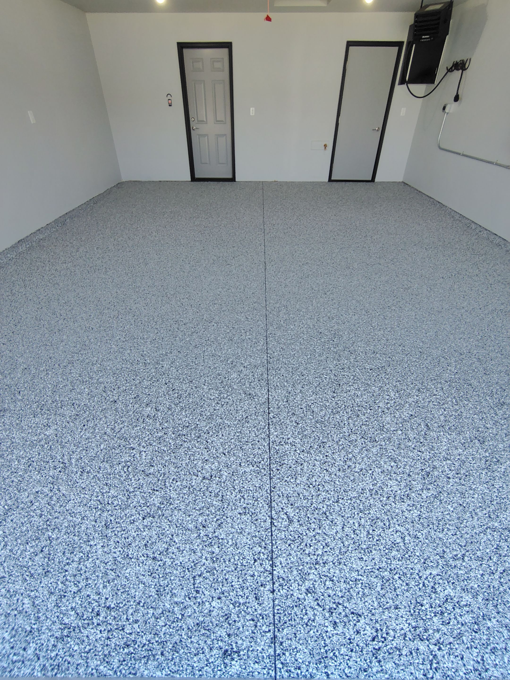 Custom Epoxy Garage Floor Coating Installation in Sioux Falls by Select Painting, Coatings & Garage Cabinets