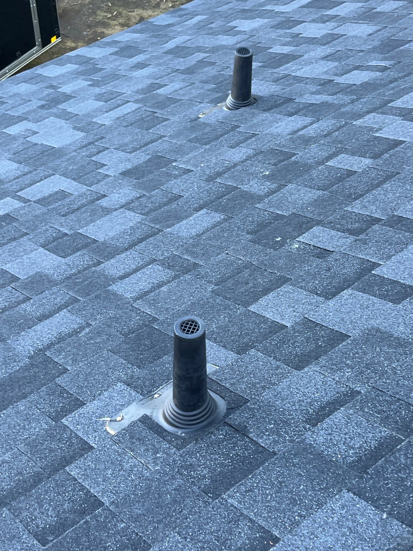 White brick with IKO Granite Black by Tejas Roofworks + Restoration