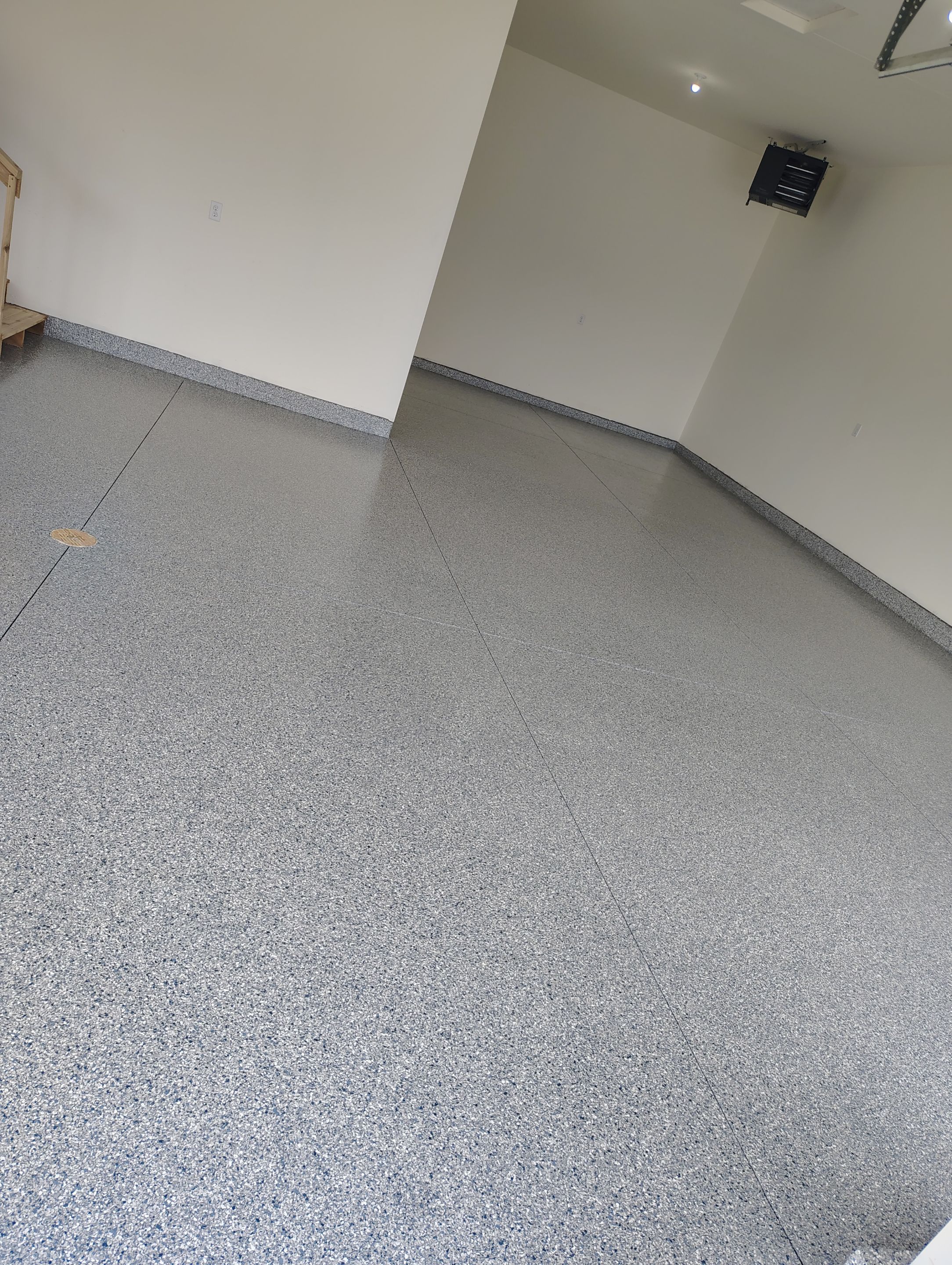 Sioux Falls Garage Floor Transformation with Gray Decorative Flake Coating by Select Painting, Coatings & Garage Cabinets