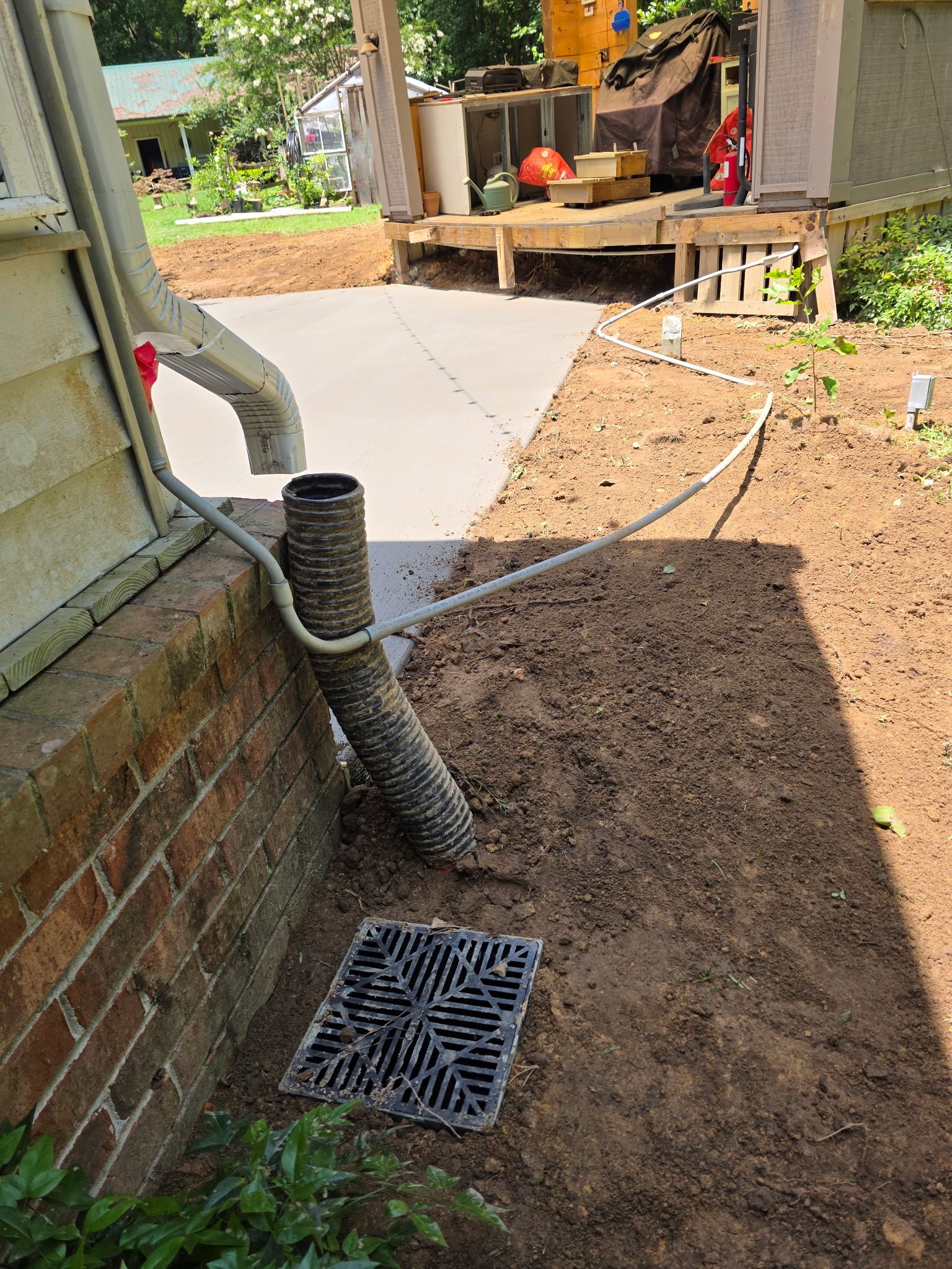 Patio in concrete with drainage improvements by Cornerstone Home Builders, LLC