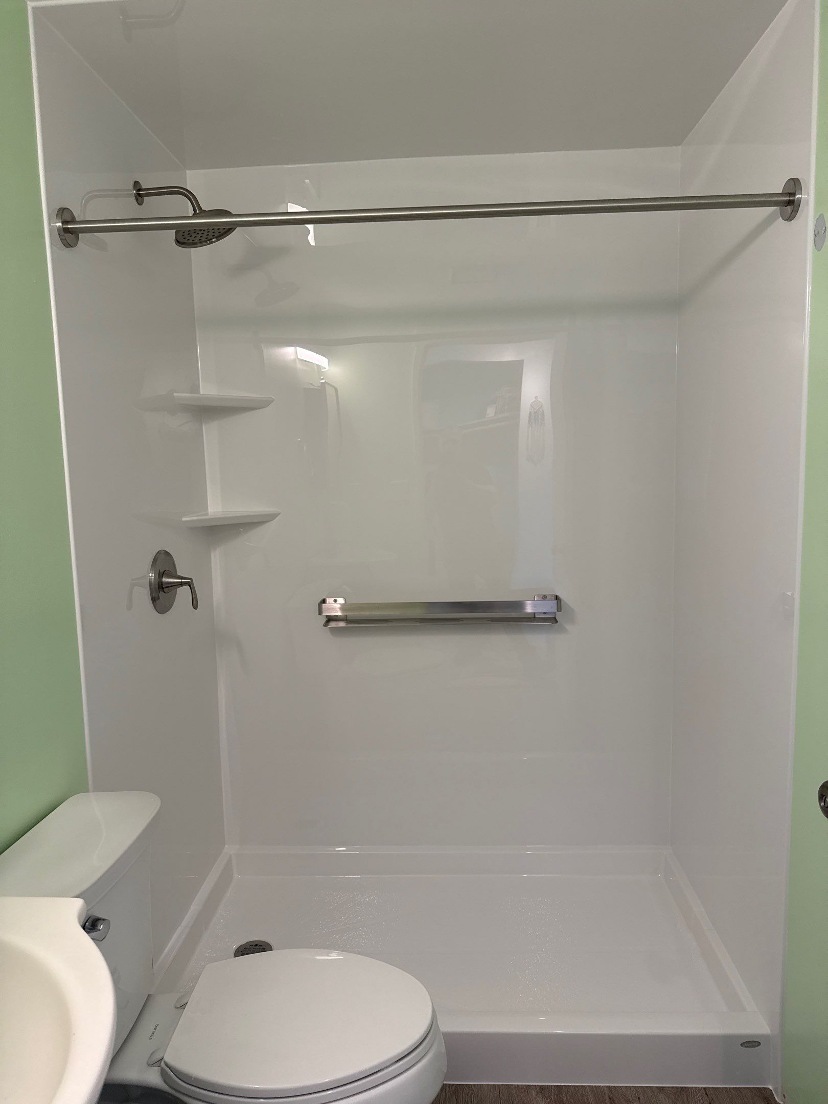 White Acrylic Walk-In Shower Installation in Boyne City by Rainbow Seamless Systems