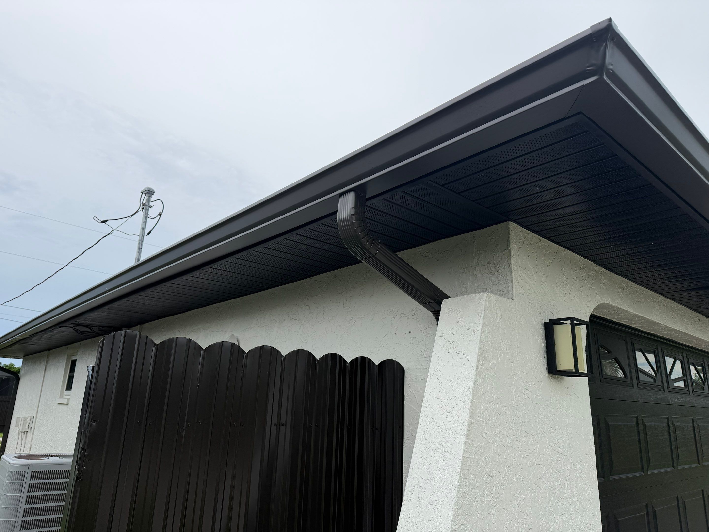Black Seamless Gutters for a Modern Look in Cape Coral FL by Gutter Professors