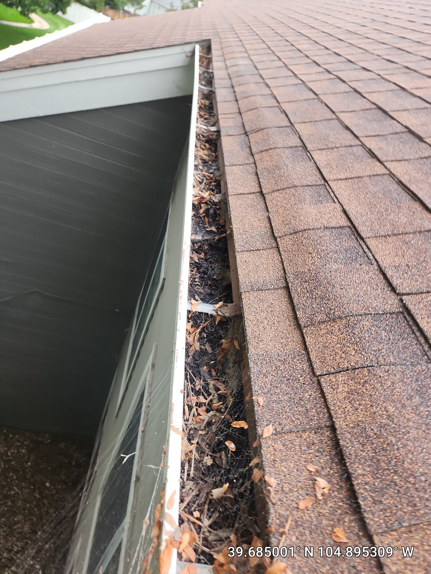 Commercial gutter cleaning Denver, CO before photo with filled gutters
