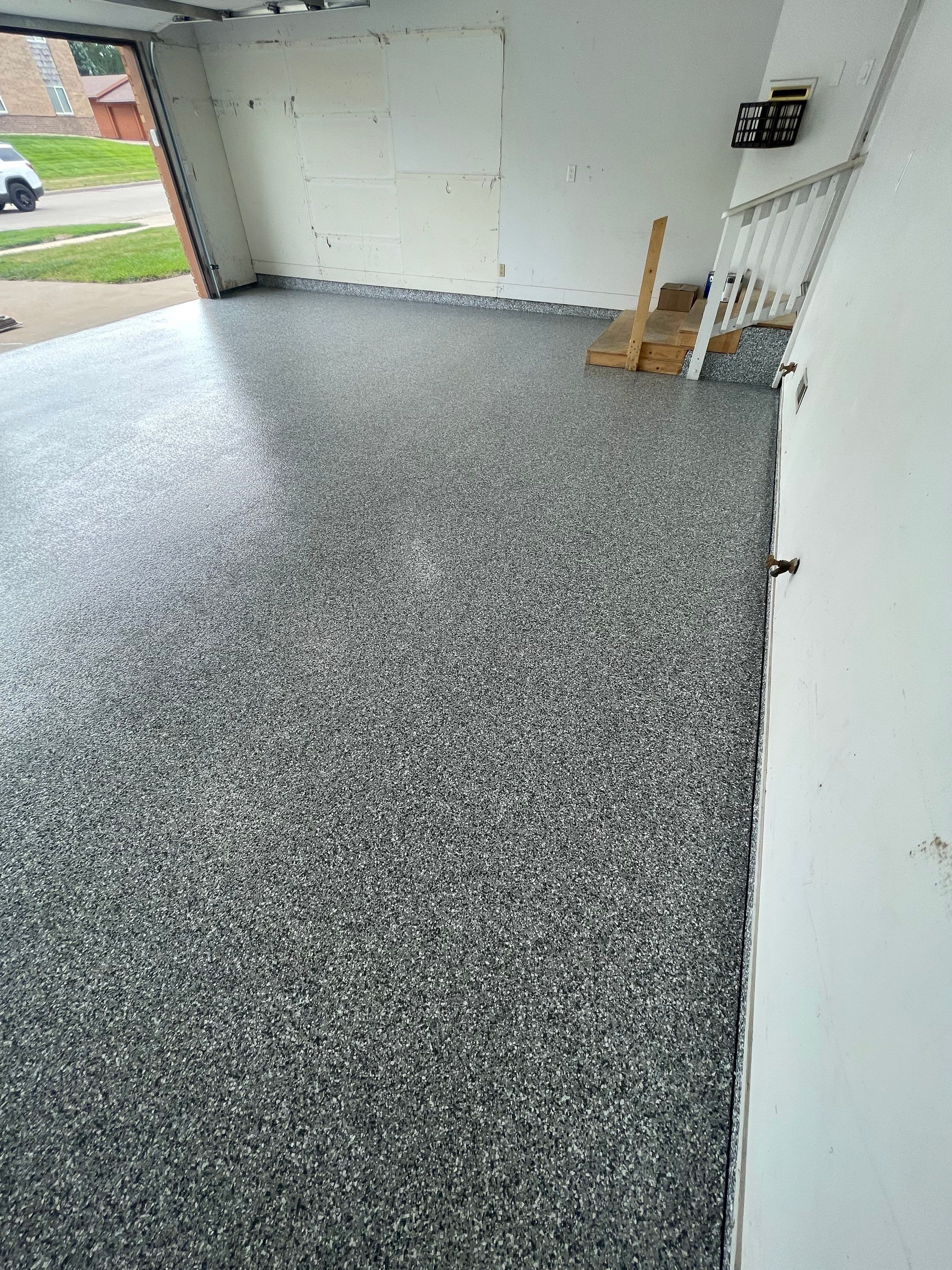 Grey Speckled Concrete Coating for Residential Garage in Yankton by Select Painting, Coatings & Garage Cabinets