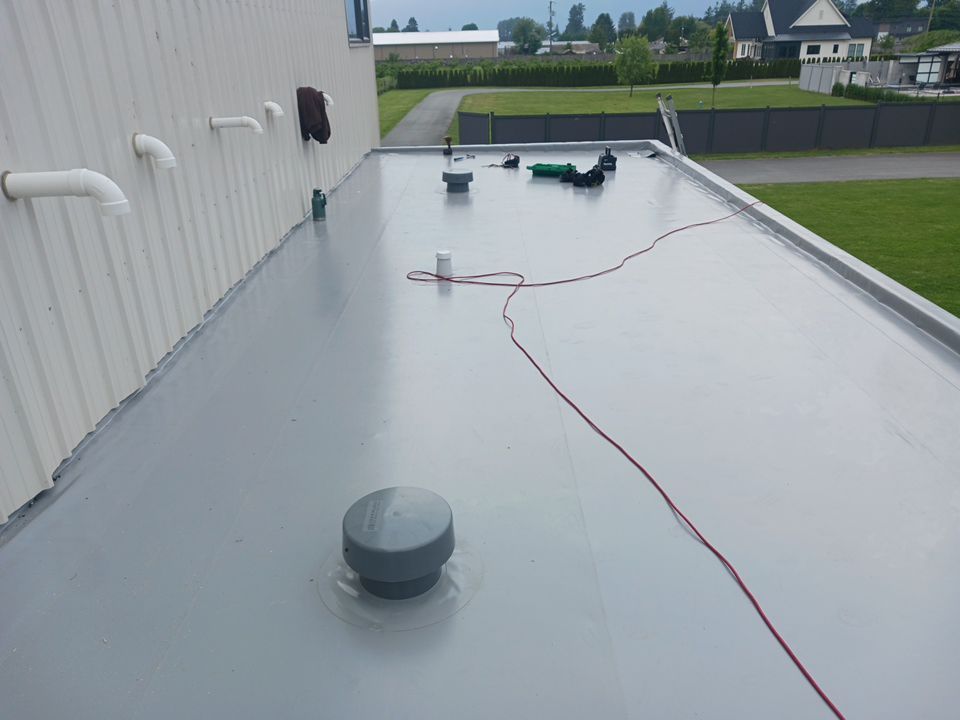 Residential Shop flat roofing Installation using Durolast membrane by Top Notch Roofing Inc