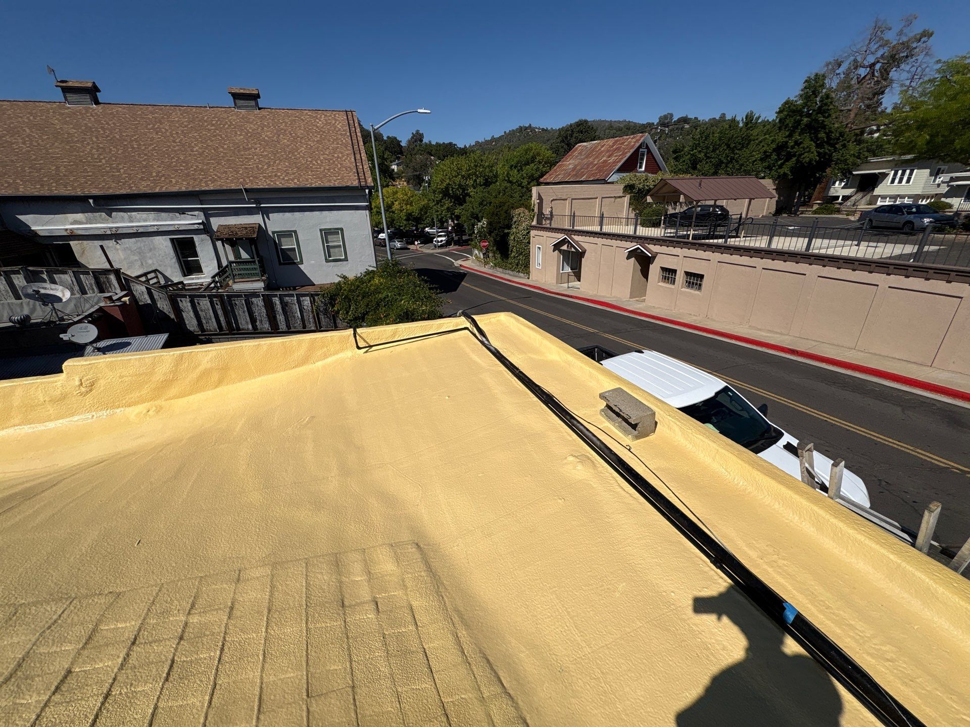Foam and coatings on commercial roof by Straight Edge Roofing Inc
