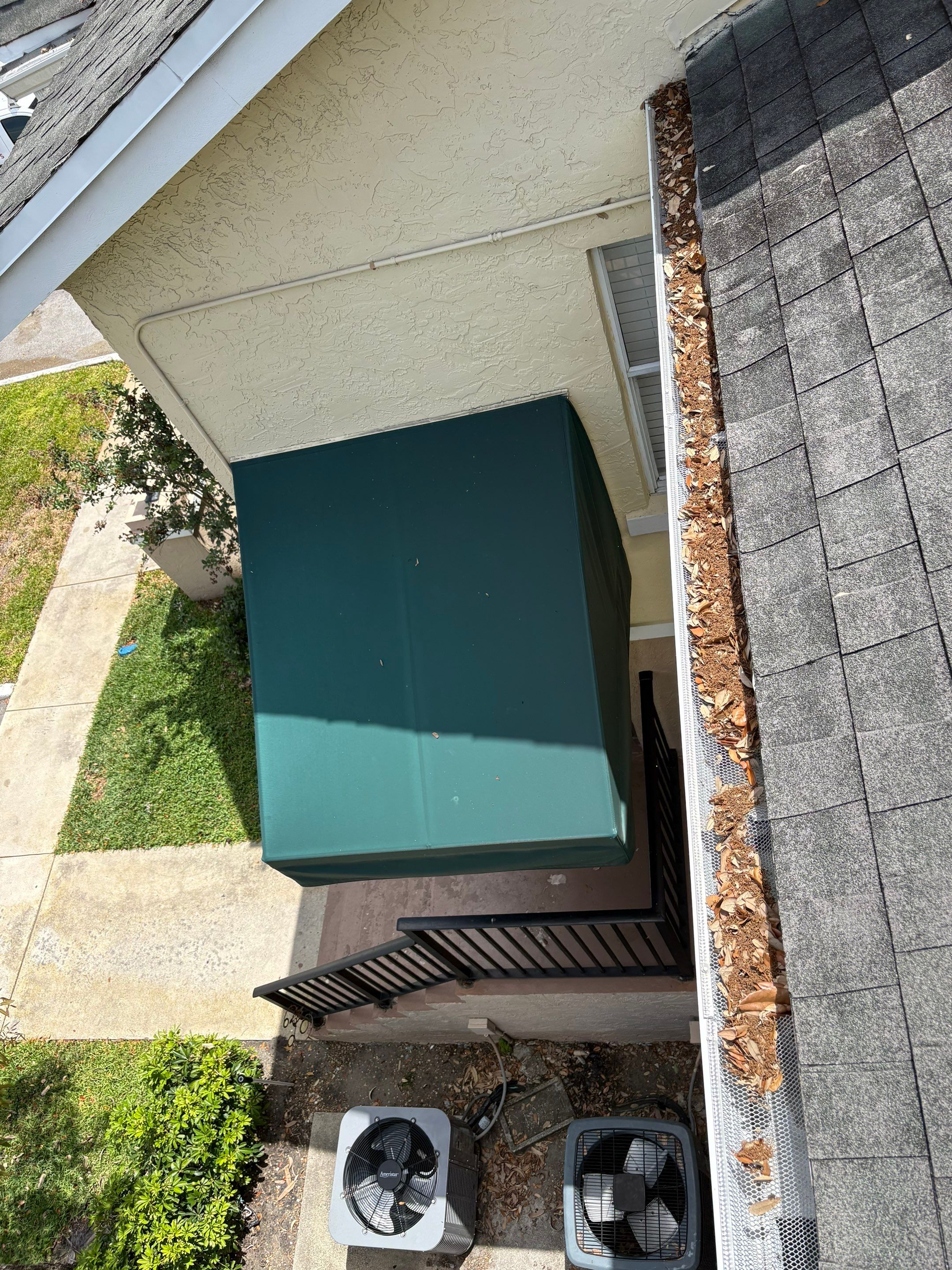 Commercial gutter cleaning Coral Springs & Pompano Beach, FL before photo with filled gutters