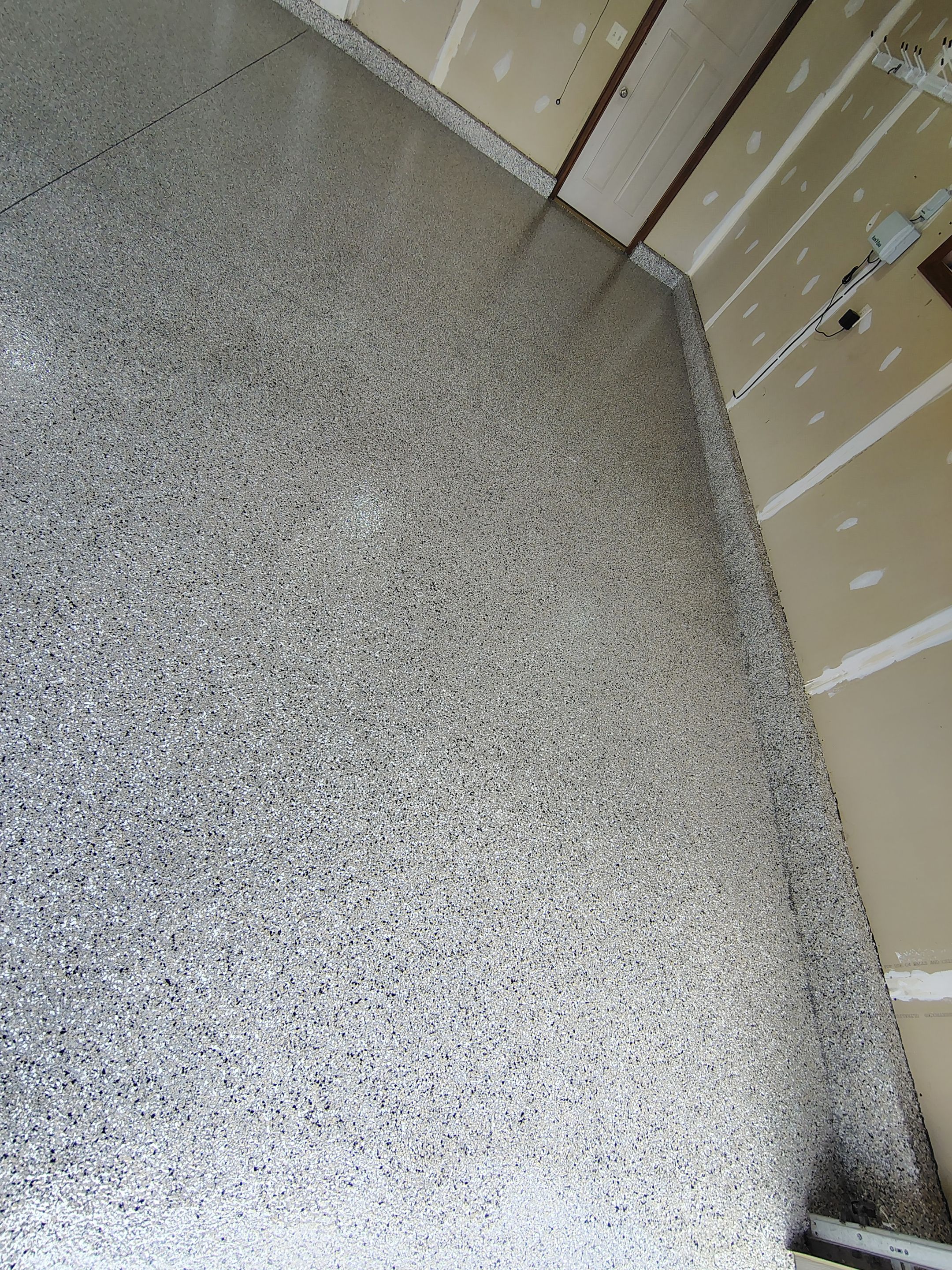 Multi-Car Garage Concrete Coating and Epoxy Finish in Sioux Falls by Select Painting, Coatings & Garage Cabinets