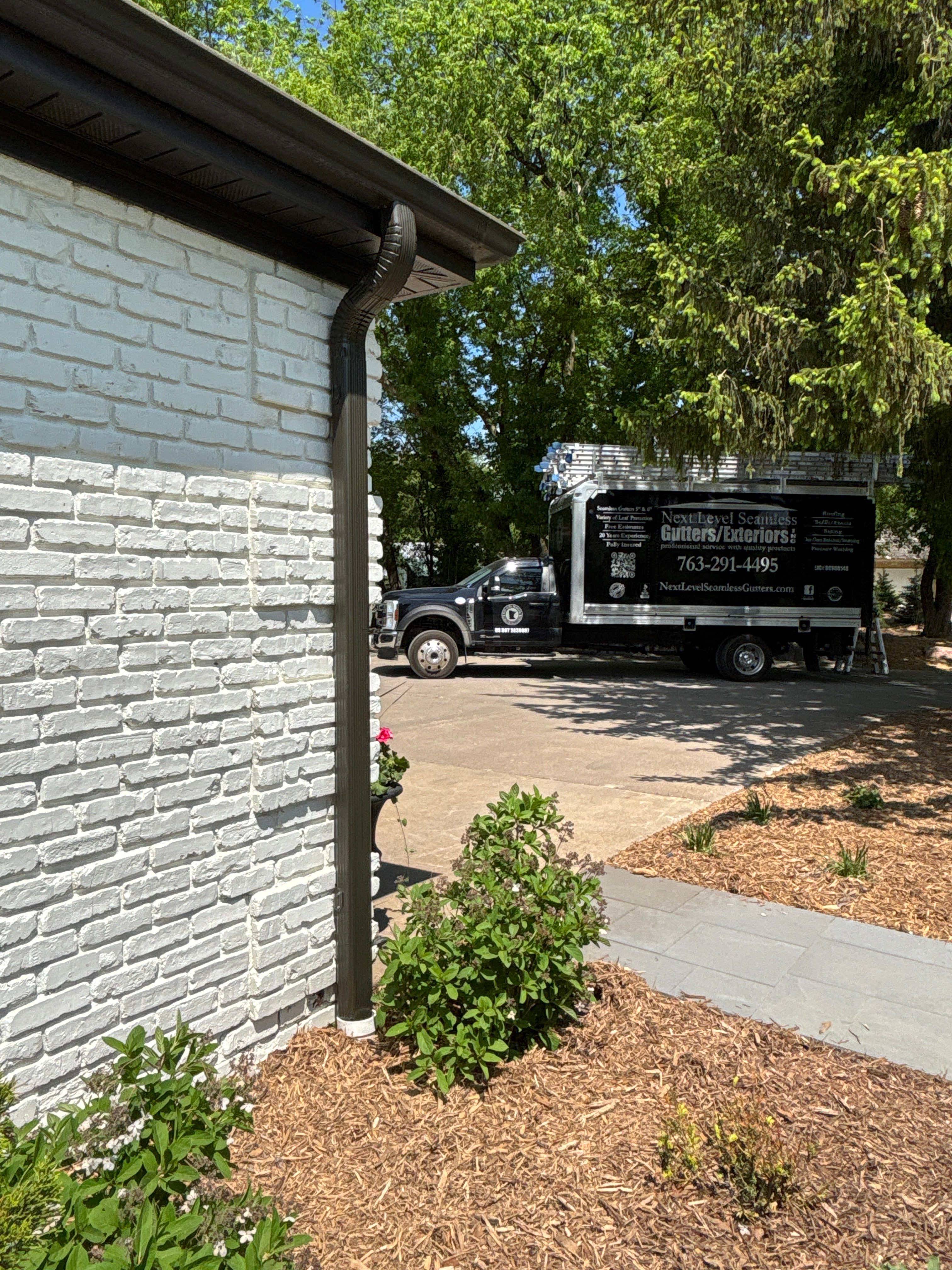 Mocha Downspout Rework – Maple Grove, MN by Next Level Seamless Gutters / Exteriors Inc.