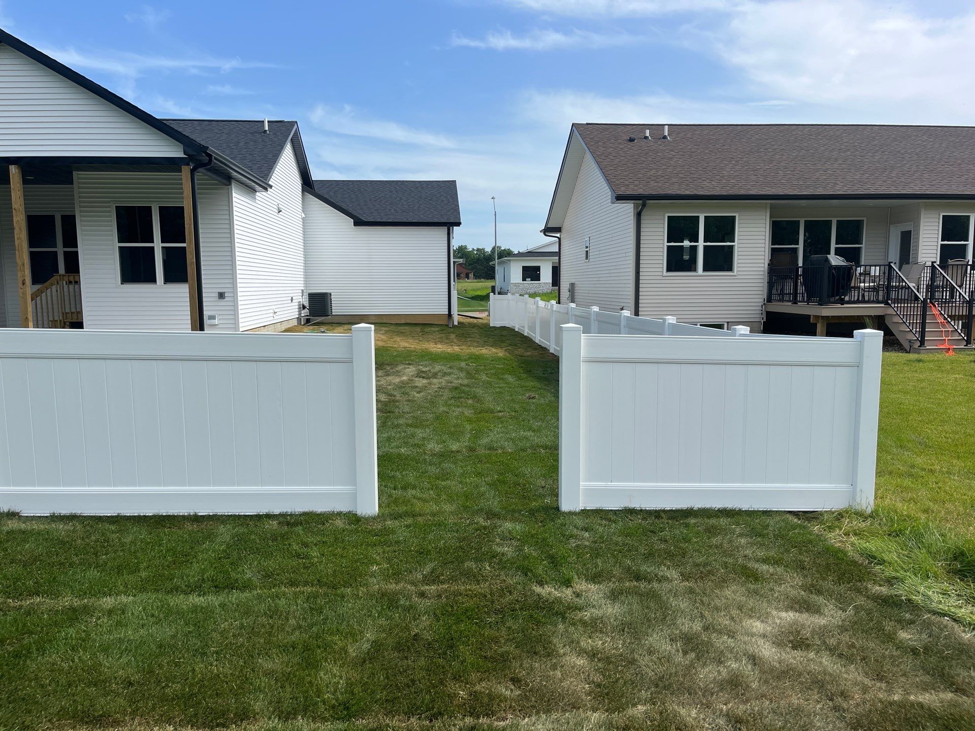 White Vinyl Privacy Fence With Pet Window in Cedar Falls by Perfect Picket Fence and Stain
