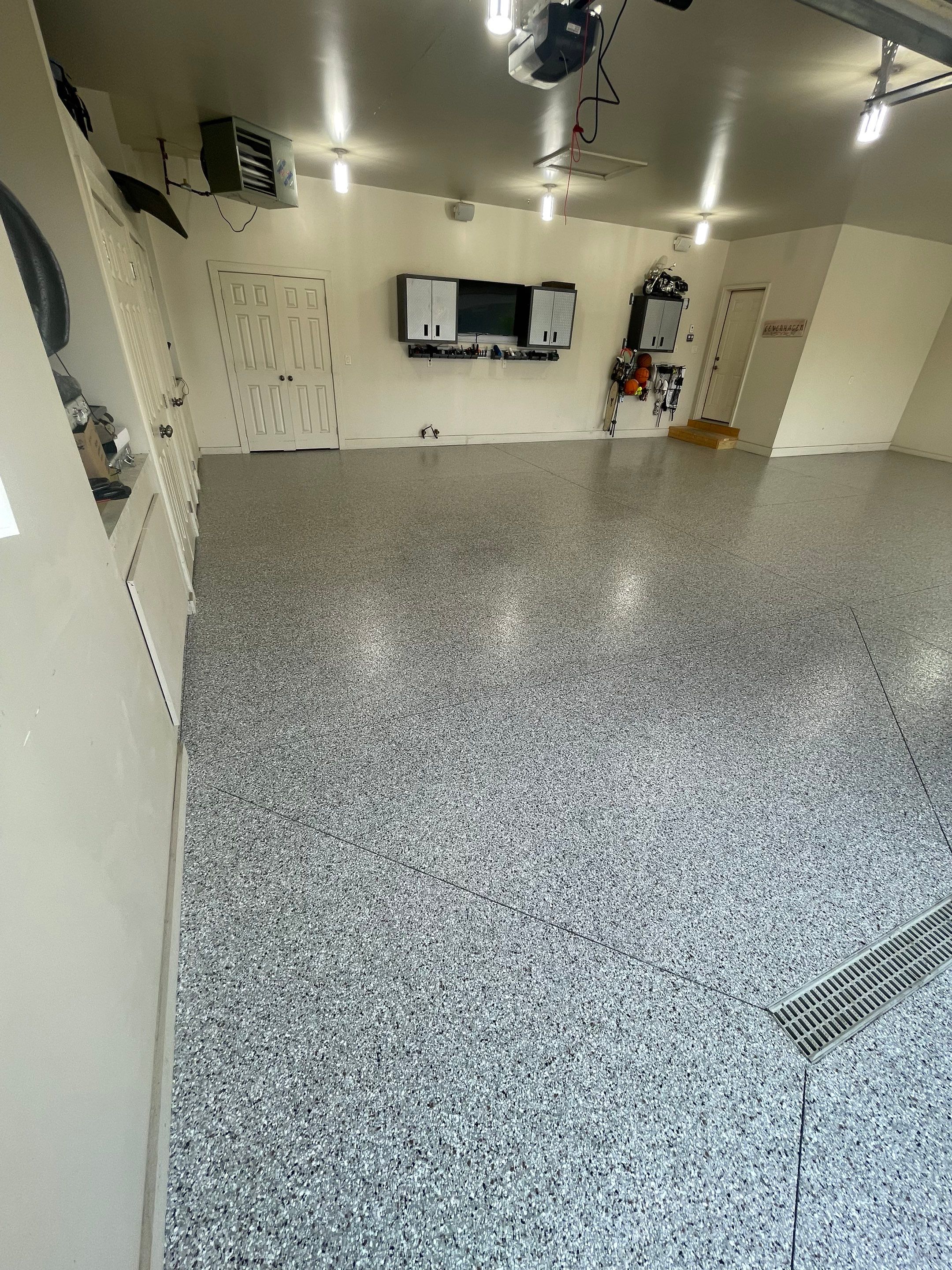 Coyote Flake Garage Floor Coating in Sioux Falls with Trench Drain by Select Painting, Coatings & Garage Cabinets