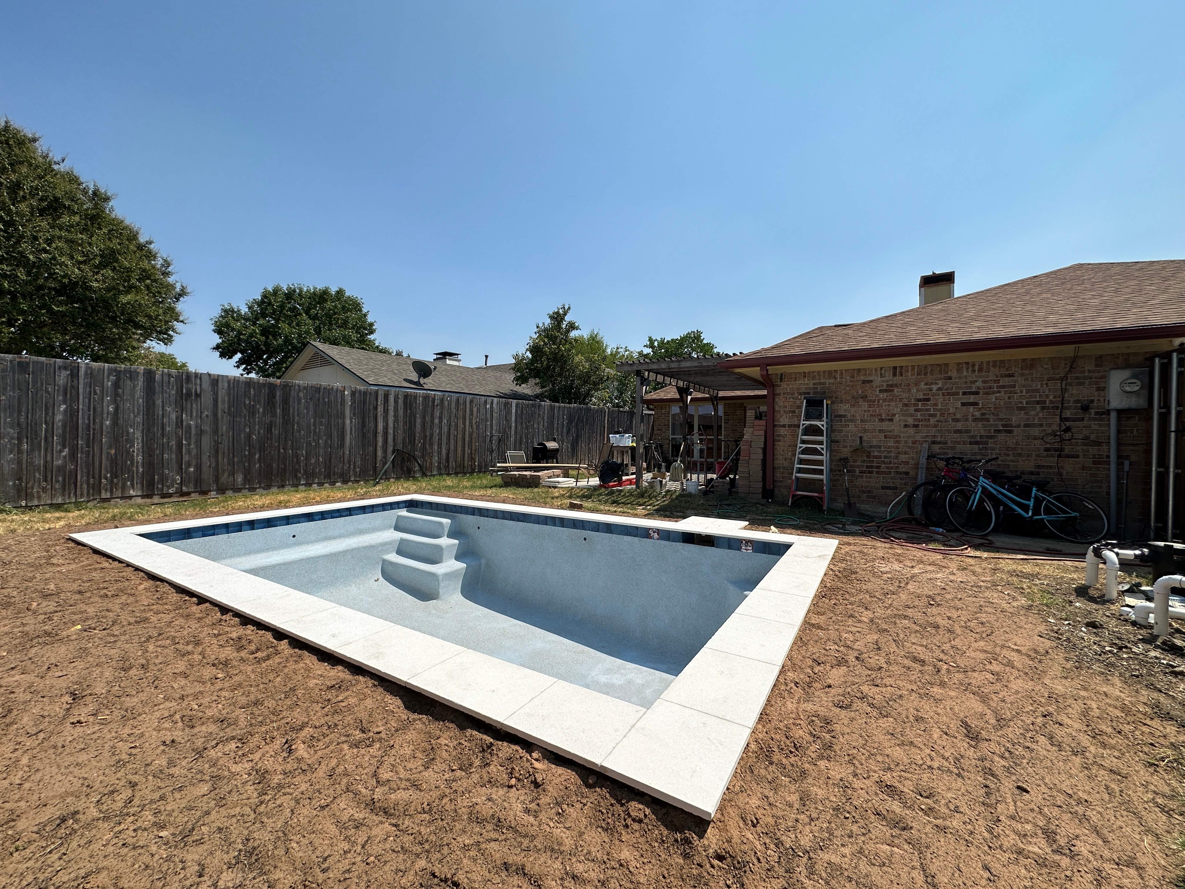 Geometric Pool with Tanning Ledge by Pinnacle Pools and Spas - DFW