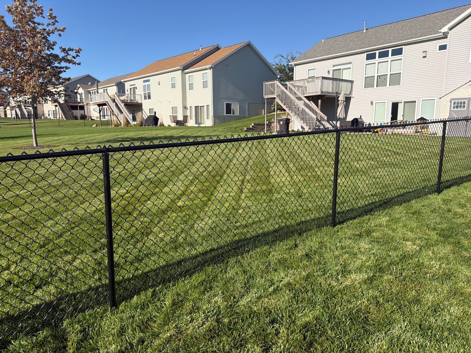 Black Vinyl-Coated Chain Link Fence Installation in Cedar Falls by Perfect Picket Fence and Stain
